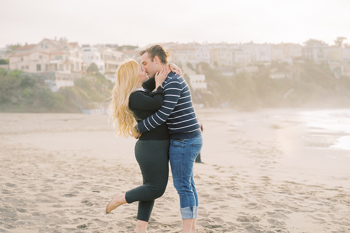 kissing engagement photo on baker beach in san francisco