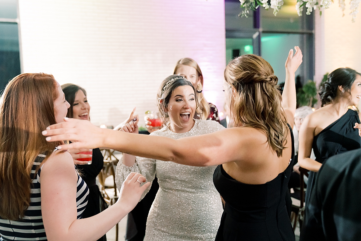 bride and friends dancing at wedding