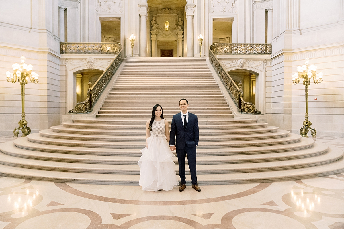 man and woman walking on stairs at San Francisco city hall