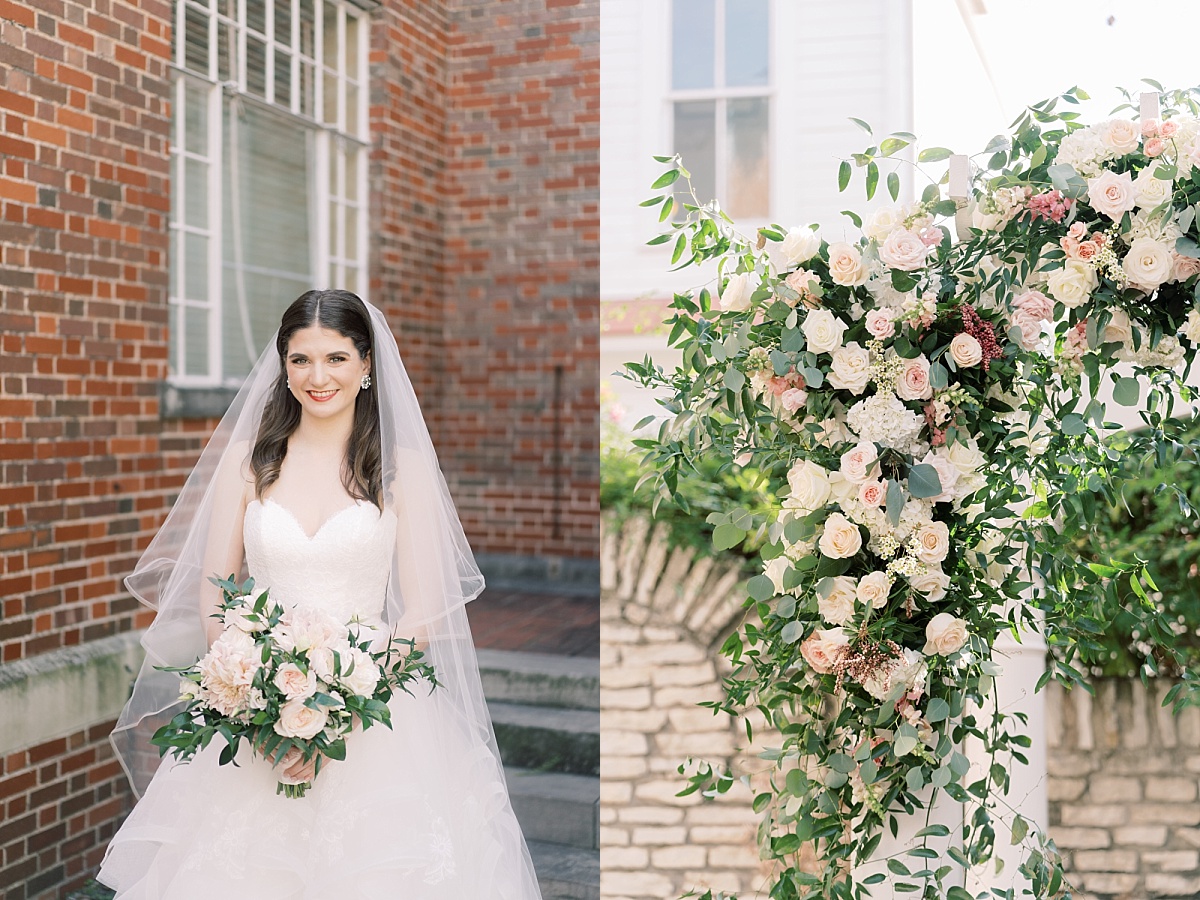 Beautiful Texas bride with long brown hair wearing a veil and holding a blush pink bouquet stands in front of a brick wall for her wedding photos at The Mansion, Austin.