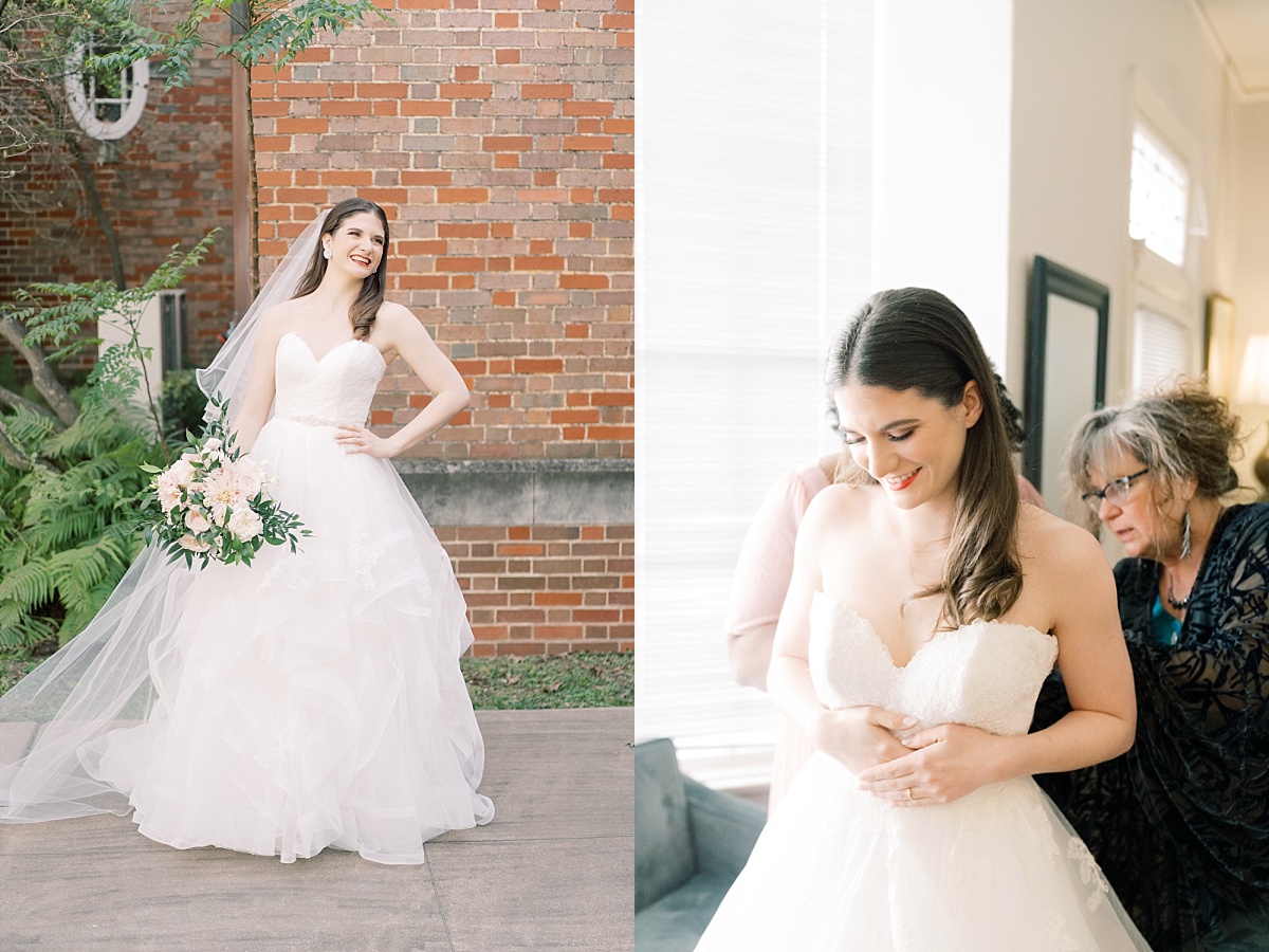 Beautiful Caucasian bride with long brown hair stands in wedding dress while holding a blush pink bouquet, posing for wedding photos with Paige Vaughn Photography in Austin, Texas.