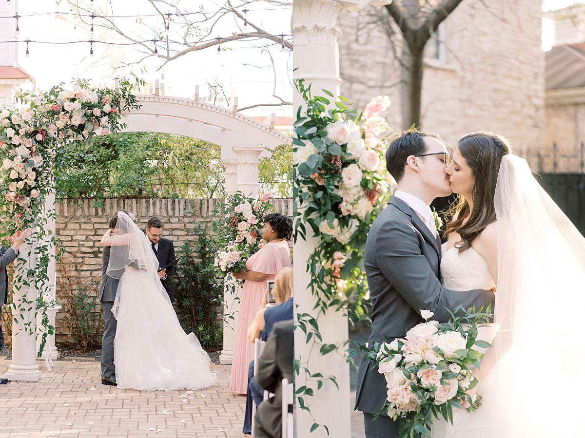 A bride and groom hold each other at a beautiful white alter covered in blush pink flowers at their outdoor wedding ceremony in Austin, Texas.