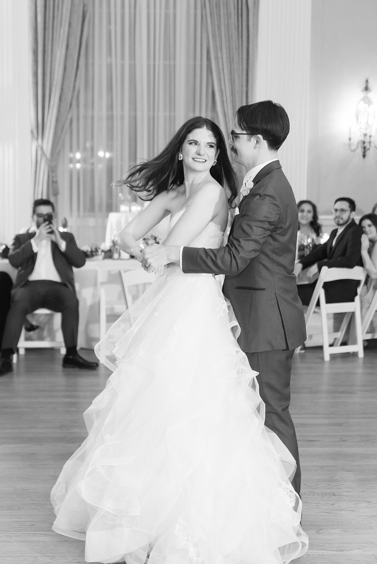 Black and white wedding photograph of a newlywed couple dancing by Paige Vaughn Photography.