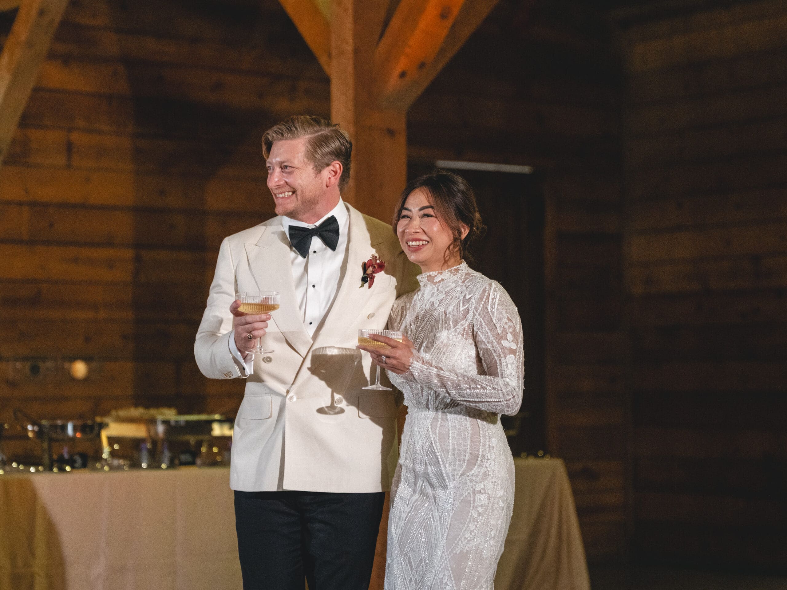 toasts Oanh and Jeremy in the barn at The Addison Grove surrounded by friends and family