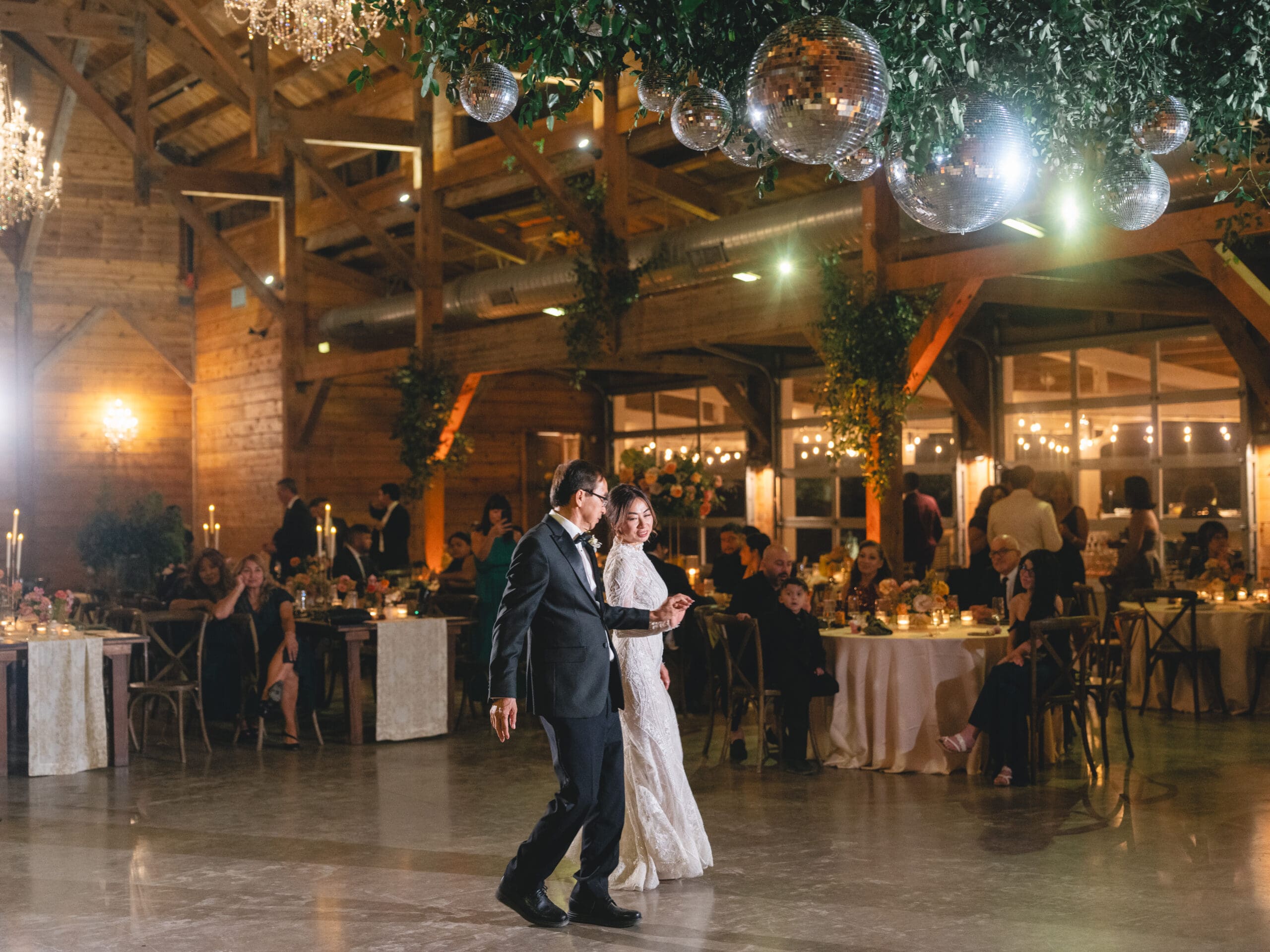 toasts Oanh and Jeremy in the barn at The Addison Grove surrounded by friends and family