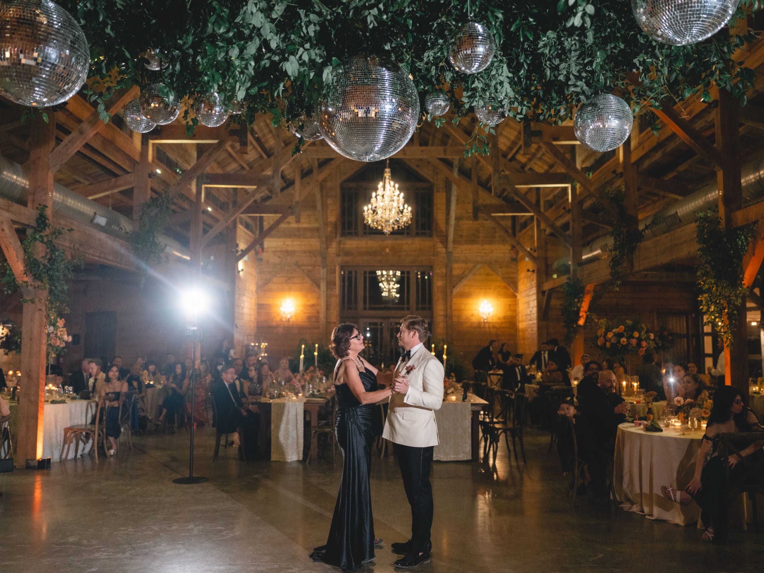 First dance moment of Oanh and Jeremy in the barn at The Addison Grove surrounded by friends and family