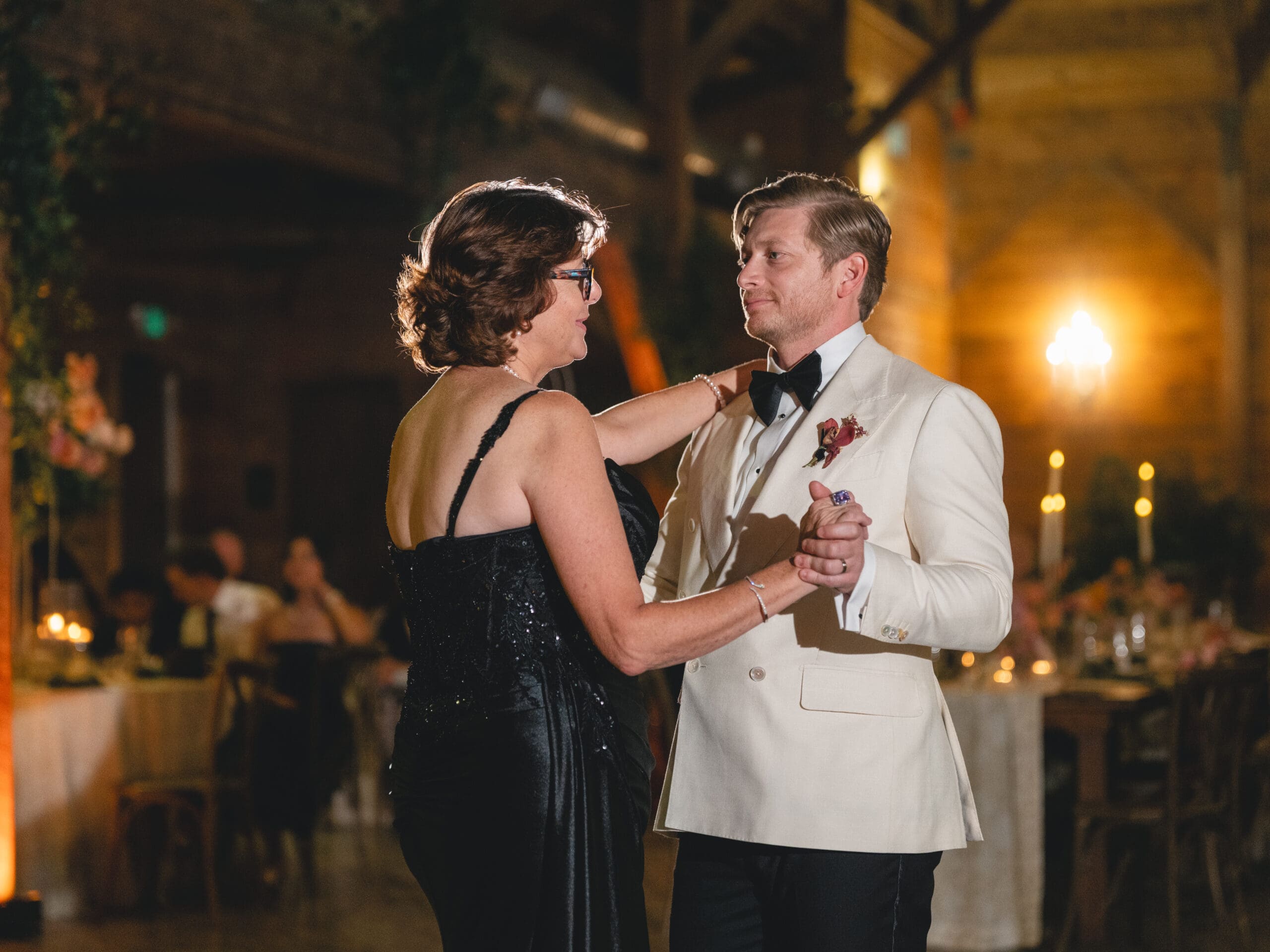First dance moment of Oanh and Jeremy in the barn at The Addison Grove surrounded by friends and family