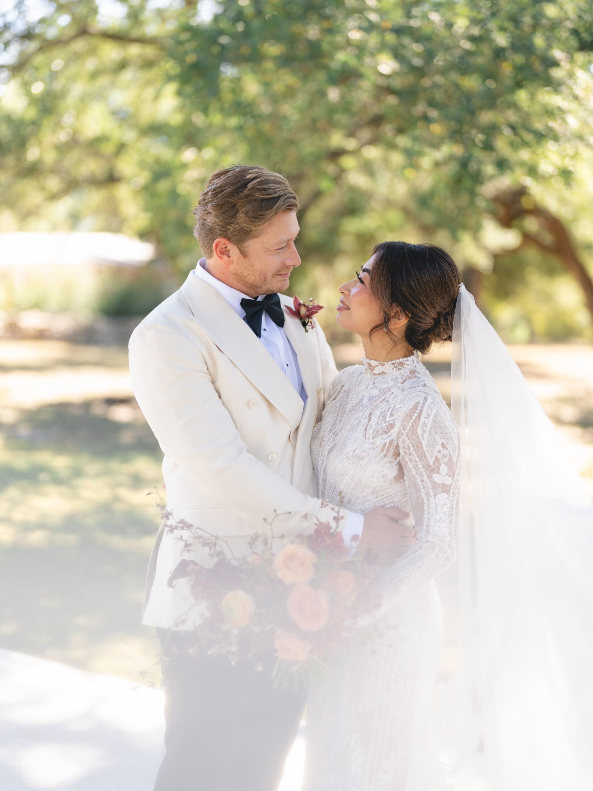 Romantic portrait of Oanh and Jeremy under the oak trees at The Addison Grove, captured on film
