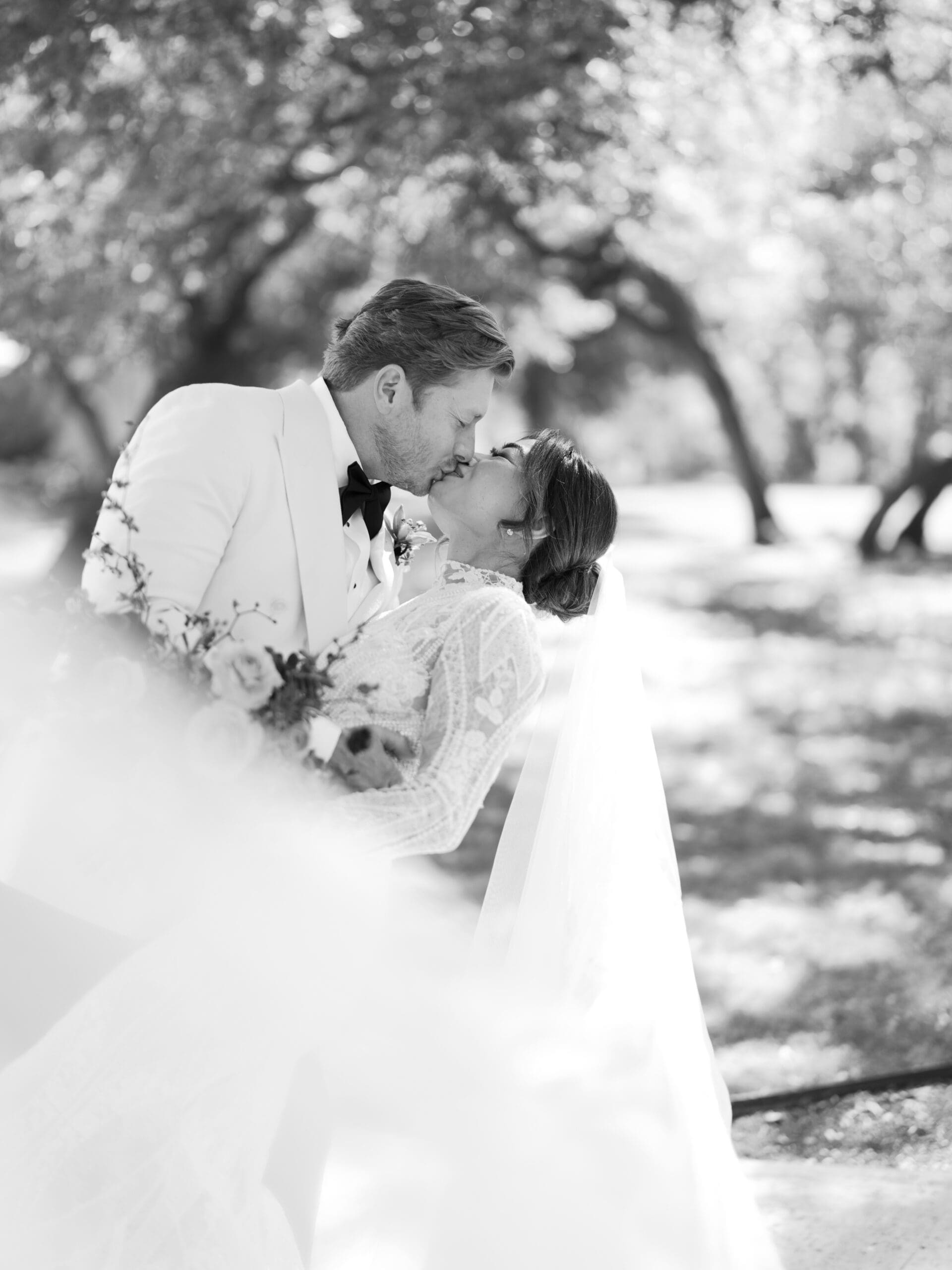 Romantic portrait of Oanh and Jeremy under the oak trees at The Addison Grove, captured on film