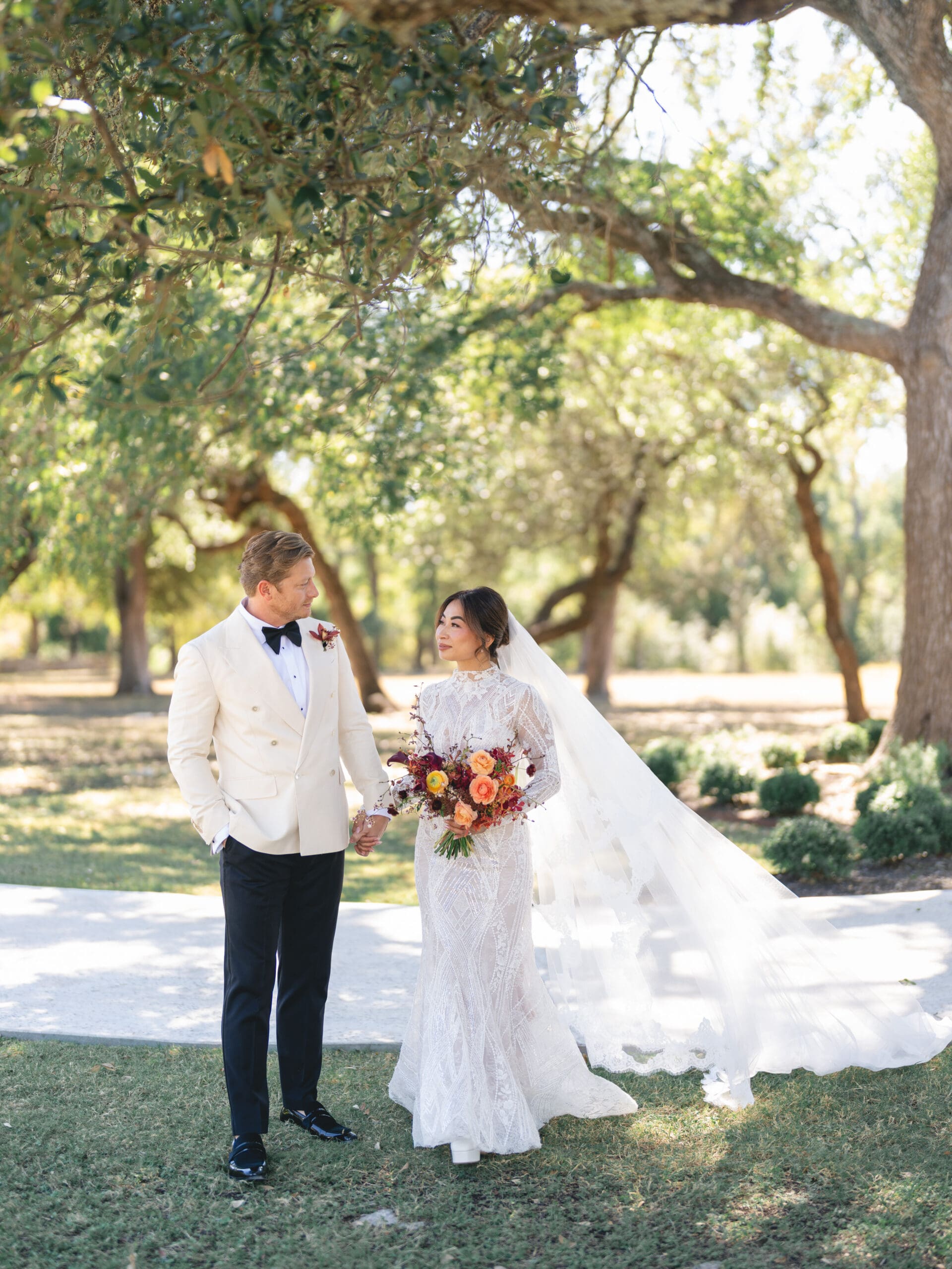 Romantic portrait of Oanh and Jeremy under the oak trees at The Addison Grove, captured on film