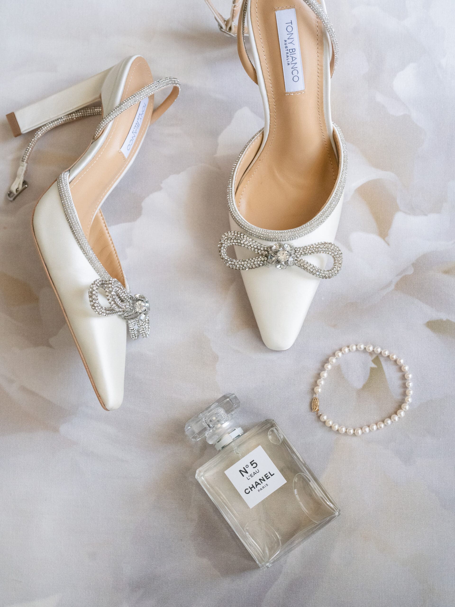 Detail photo of invitation suite, rings, and florals from Oanh and Jeremy’s Addison Grove wedding captured by Paige Vaughn Photo