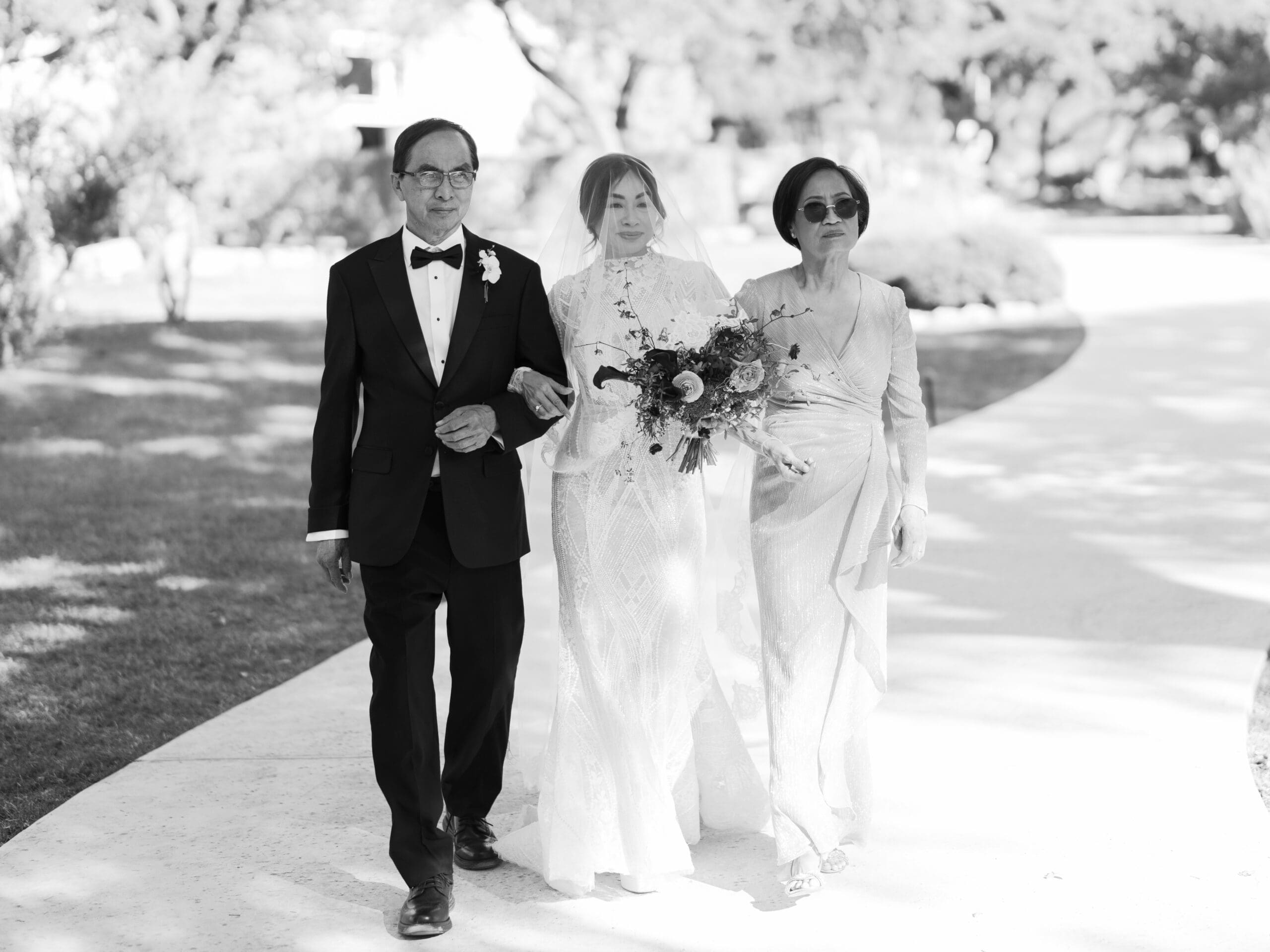 Outdoor ceremony at The Addison Grove with guests seated beneath twinkling lights and oak trees
