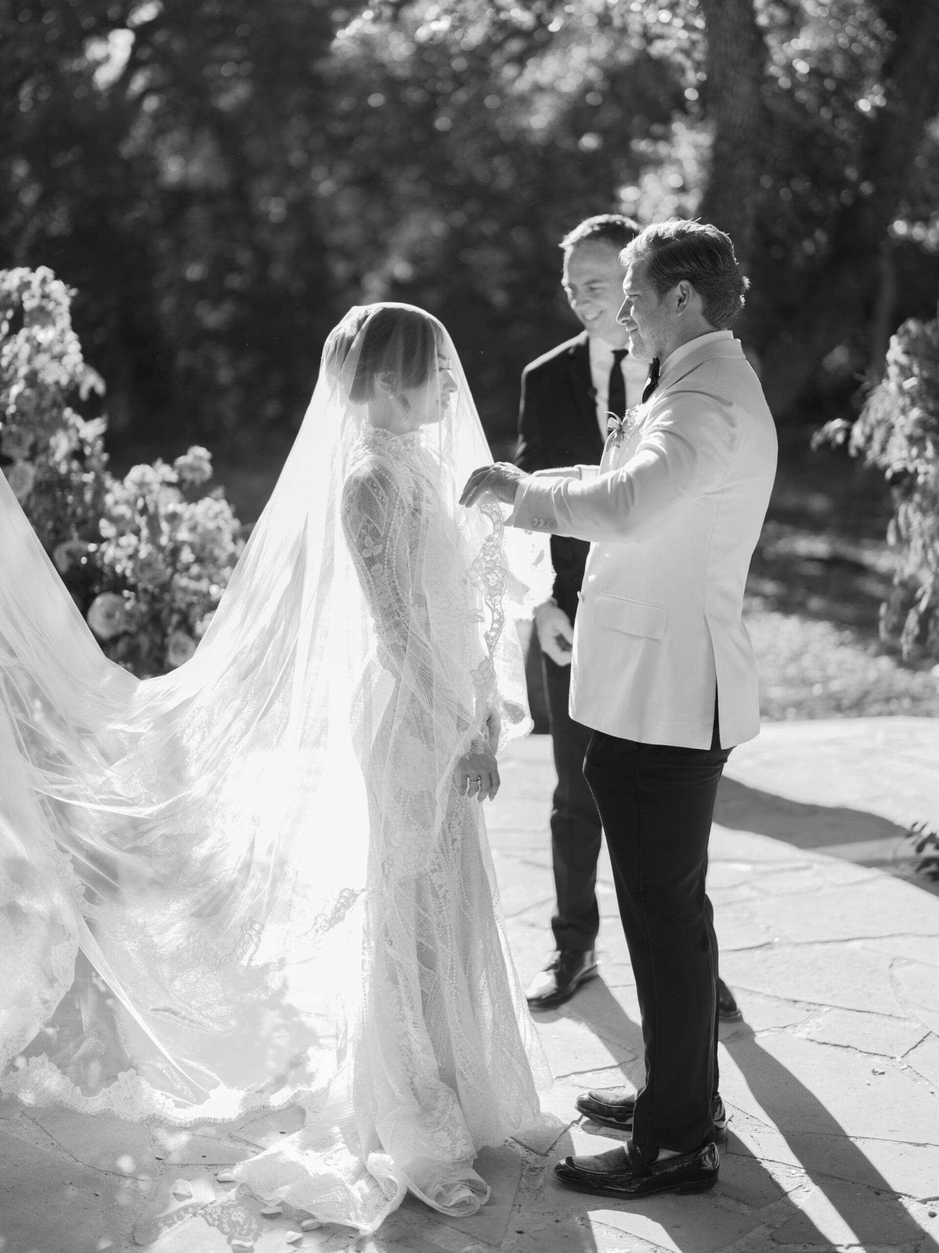 Outdoor ceremony at The Addison Grove with guests seated beneath twinkling lights and oak trees