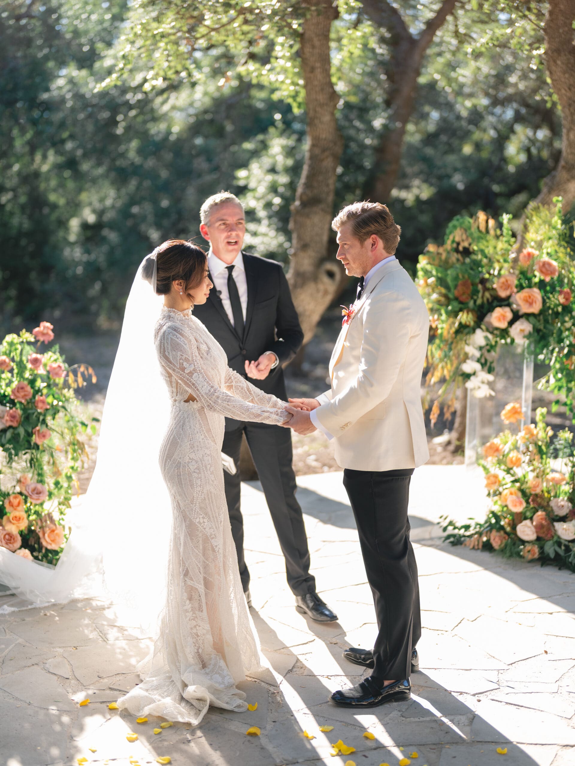 Outdoor ceremony at The Addison Grove with guests seated beneath twinkling lights and oak trees