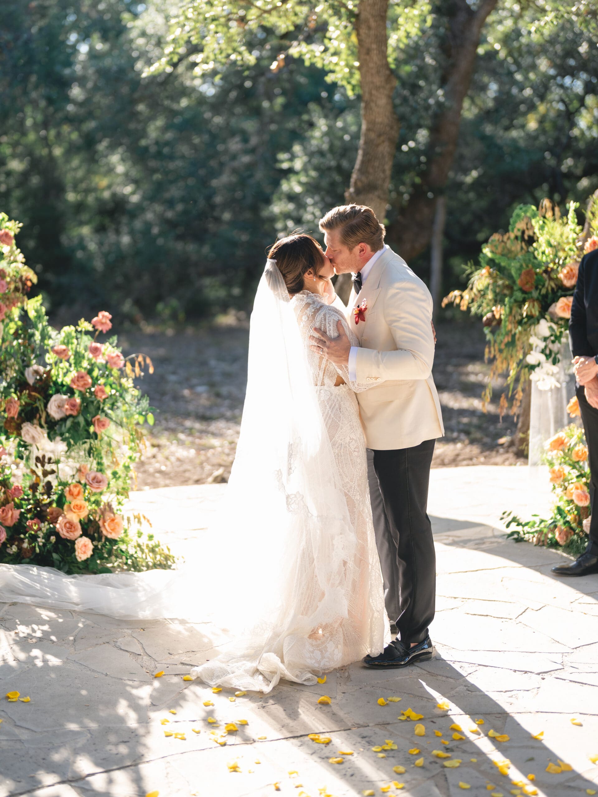 Outdoor ceremony at The Addison Grove with guests seated beneath twinkling lights and oak trees