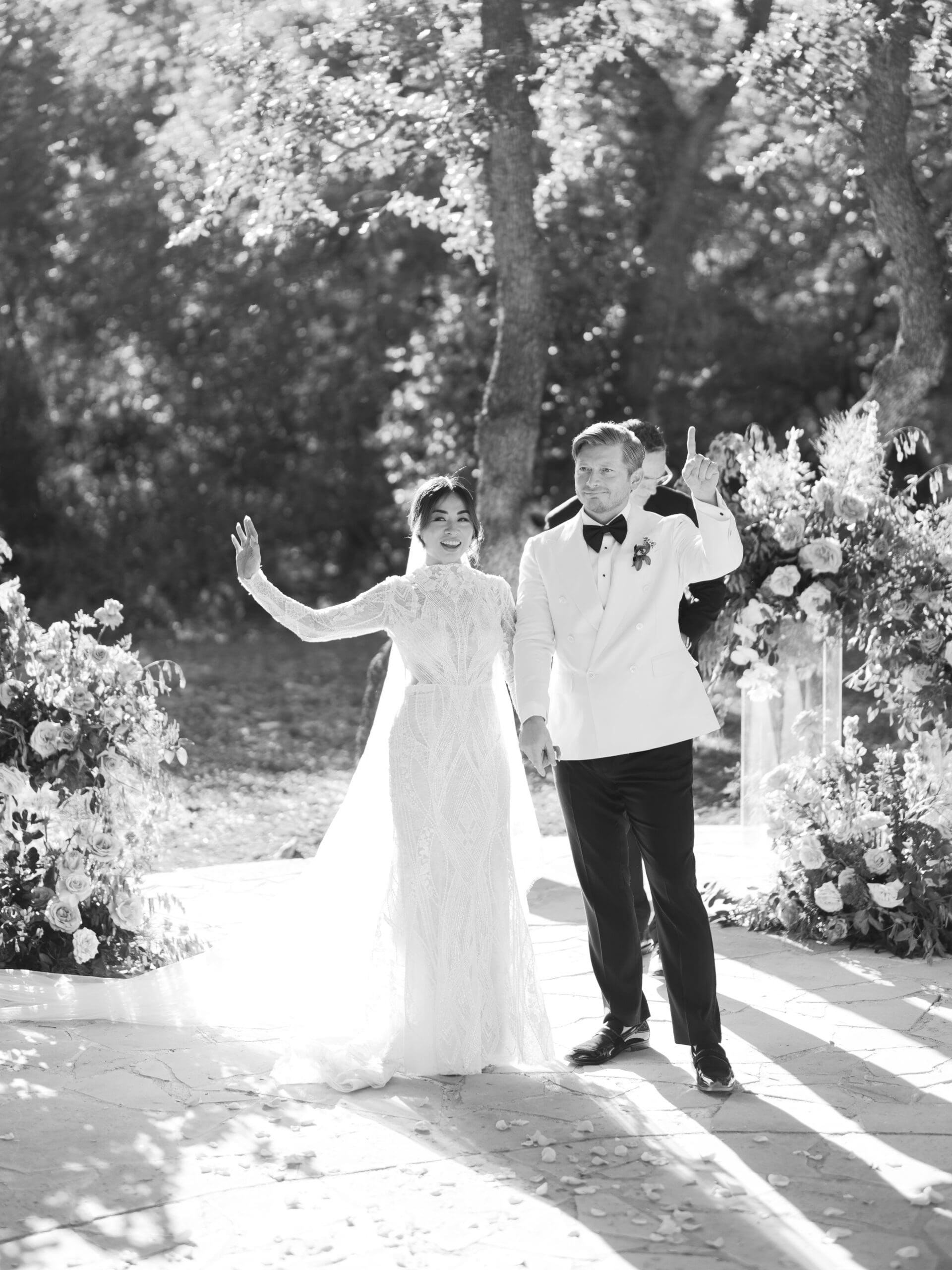 Outdoor ceremony at The Addison Grove with guests seated beneath twinkling lights and oak trees