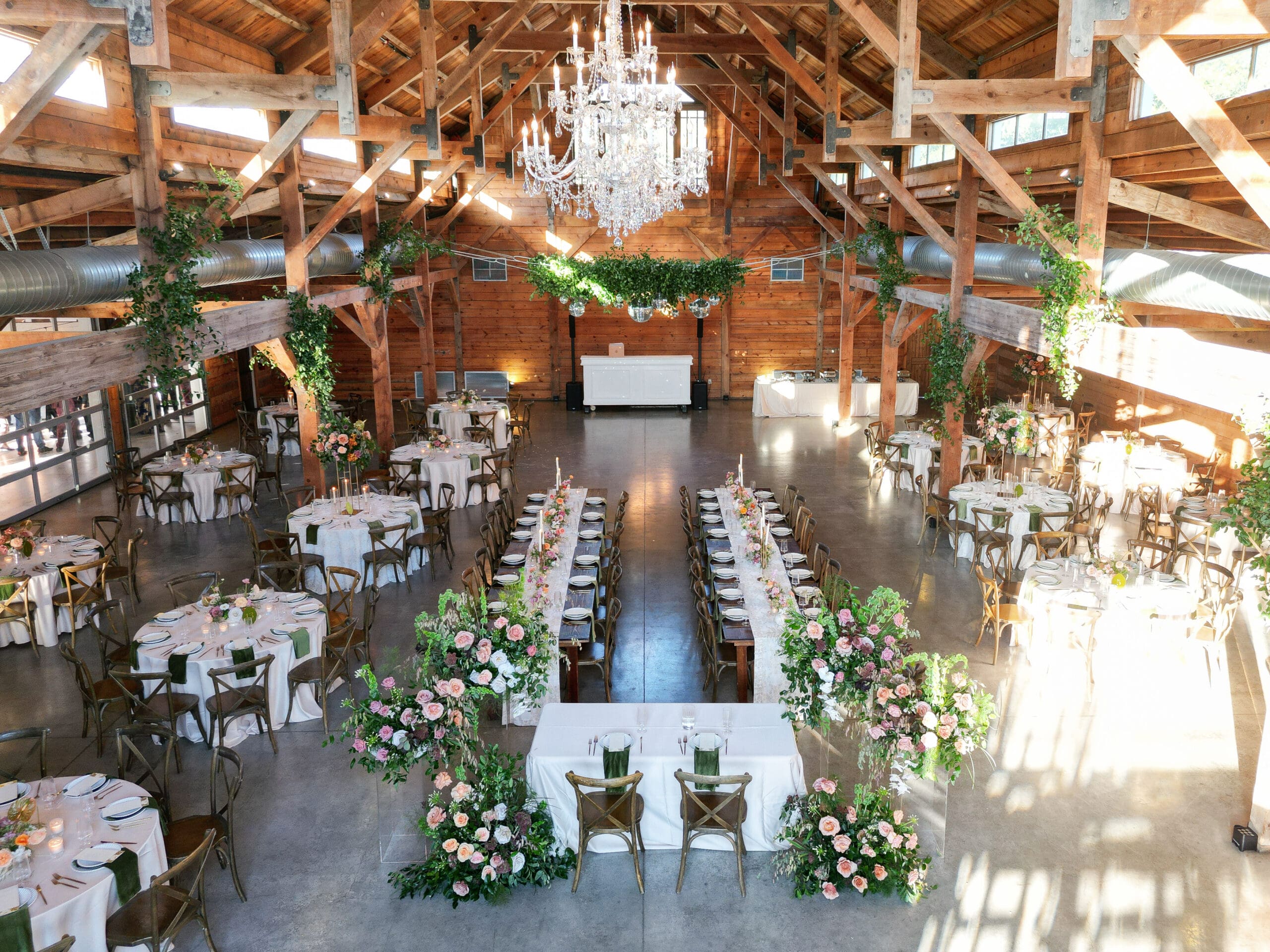 Reception details with floral centerpieces, candlelight, and elegant table settings at The Addison Grove