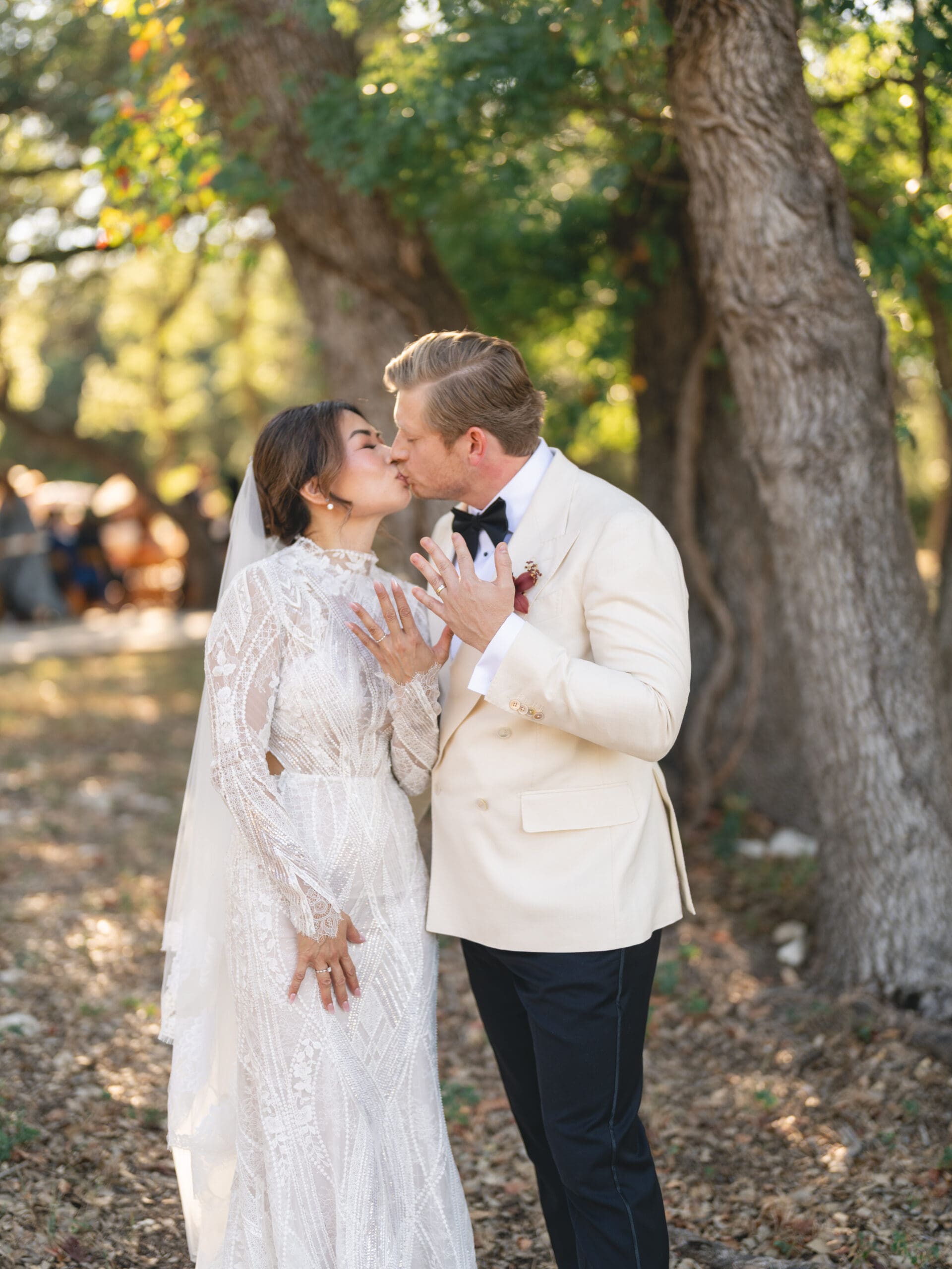 Outdoor ceremony at The Addison Grove with guests seated beneath twinkling lights and oak trees