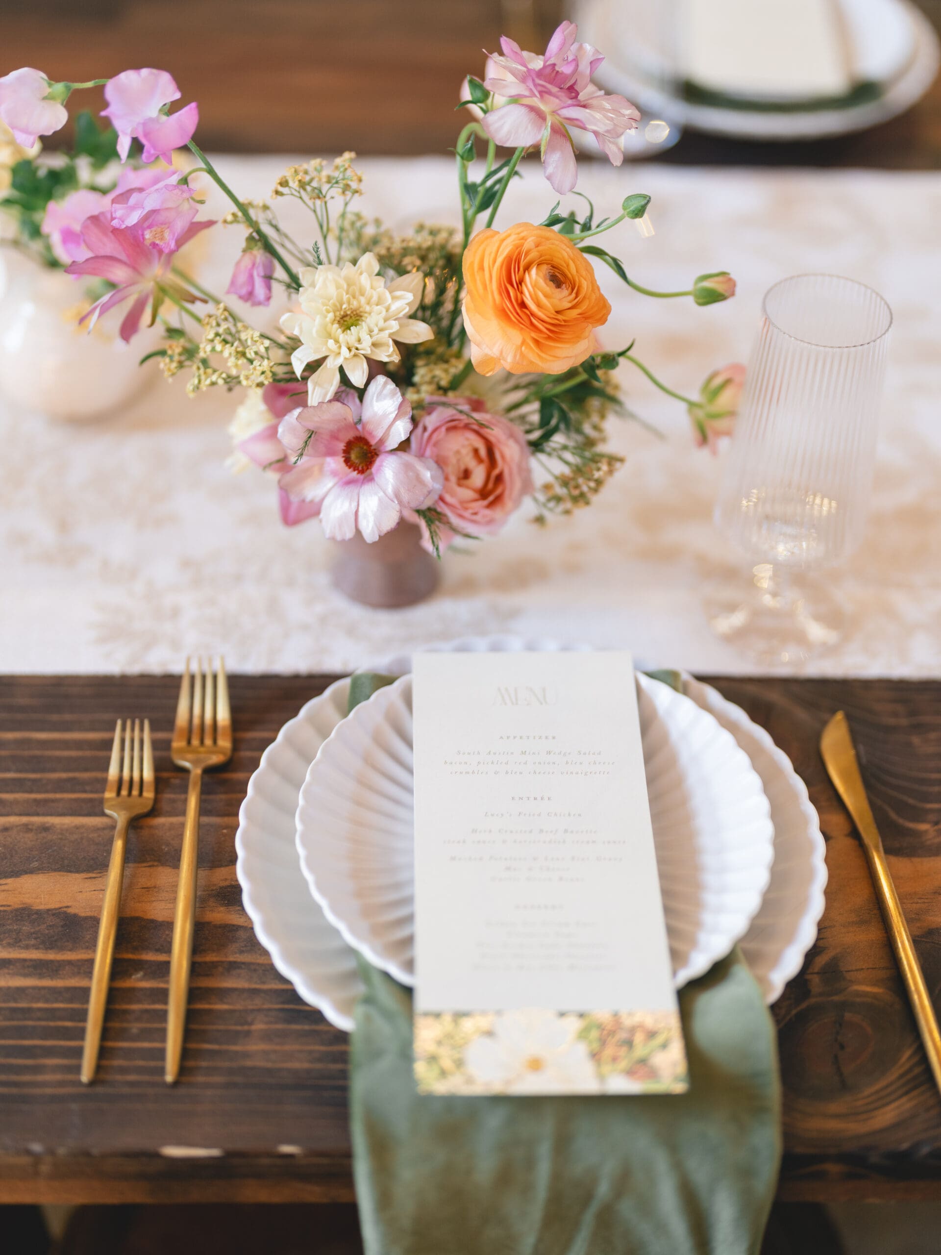 Reception details with floral centerpieces, candlelight, and elegant table settings at The Addison Grove
