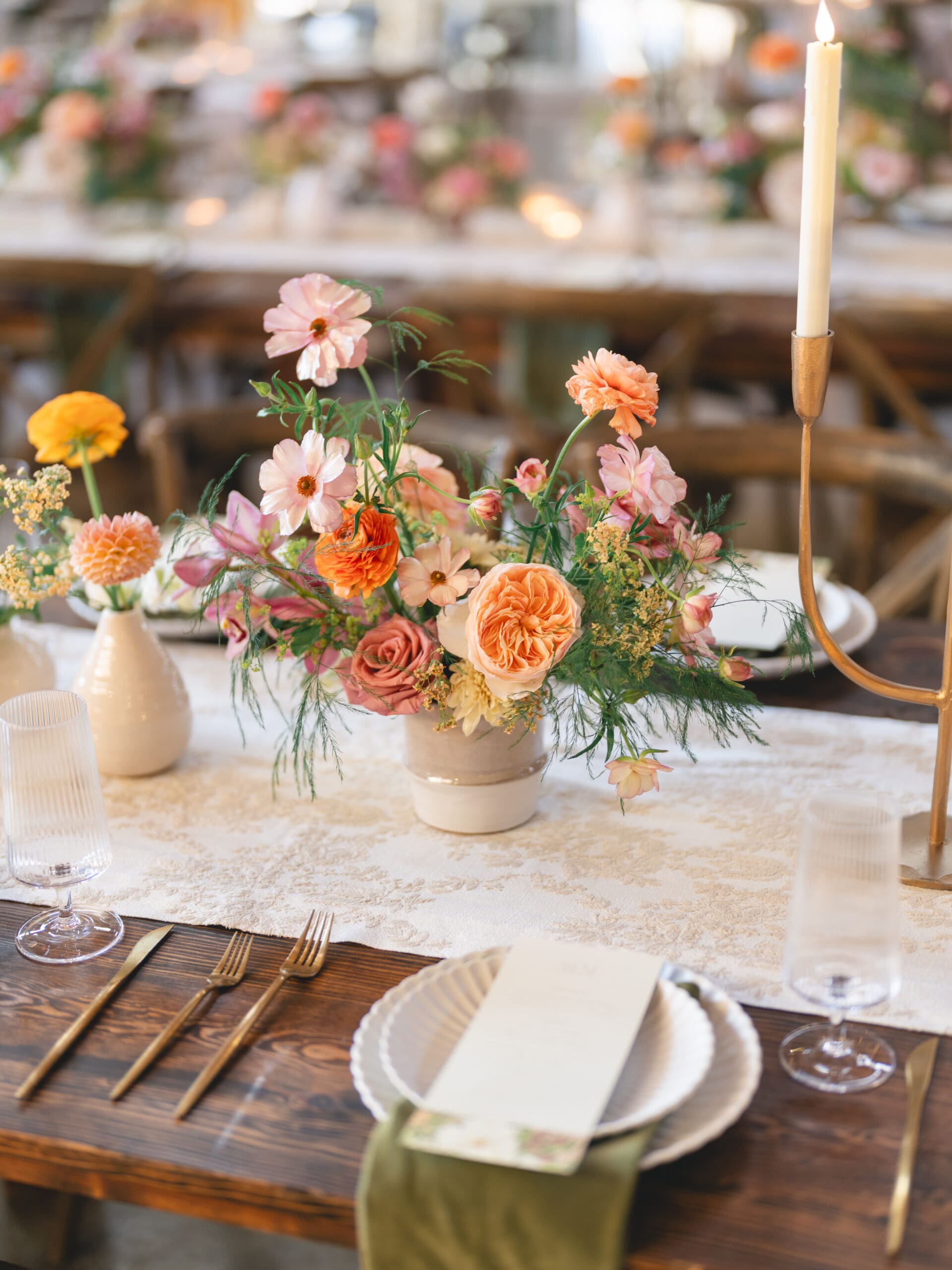Reception details with floral centerpieces, candlelight, and elegant table settings at The Addison Grove