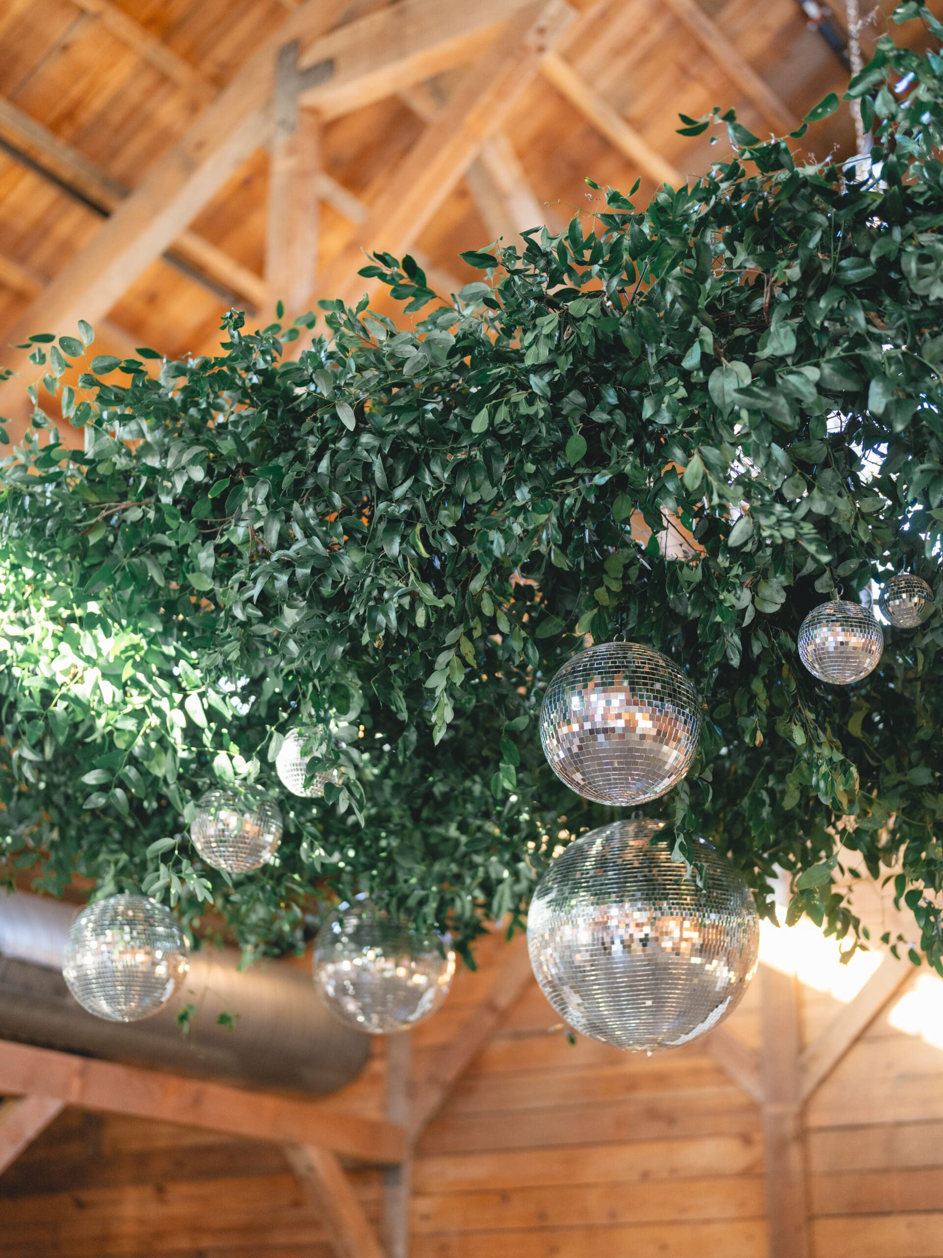 Reception details with floral centerpieces, candlelight, and elegant table settings at The Addison Grove, disco ball dance floor