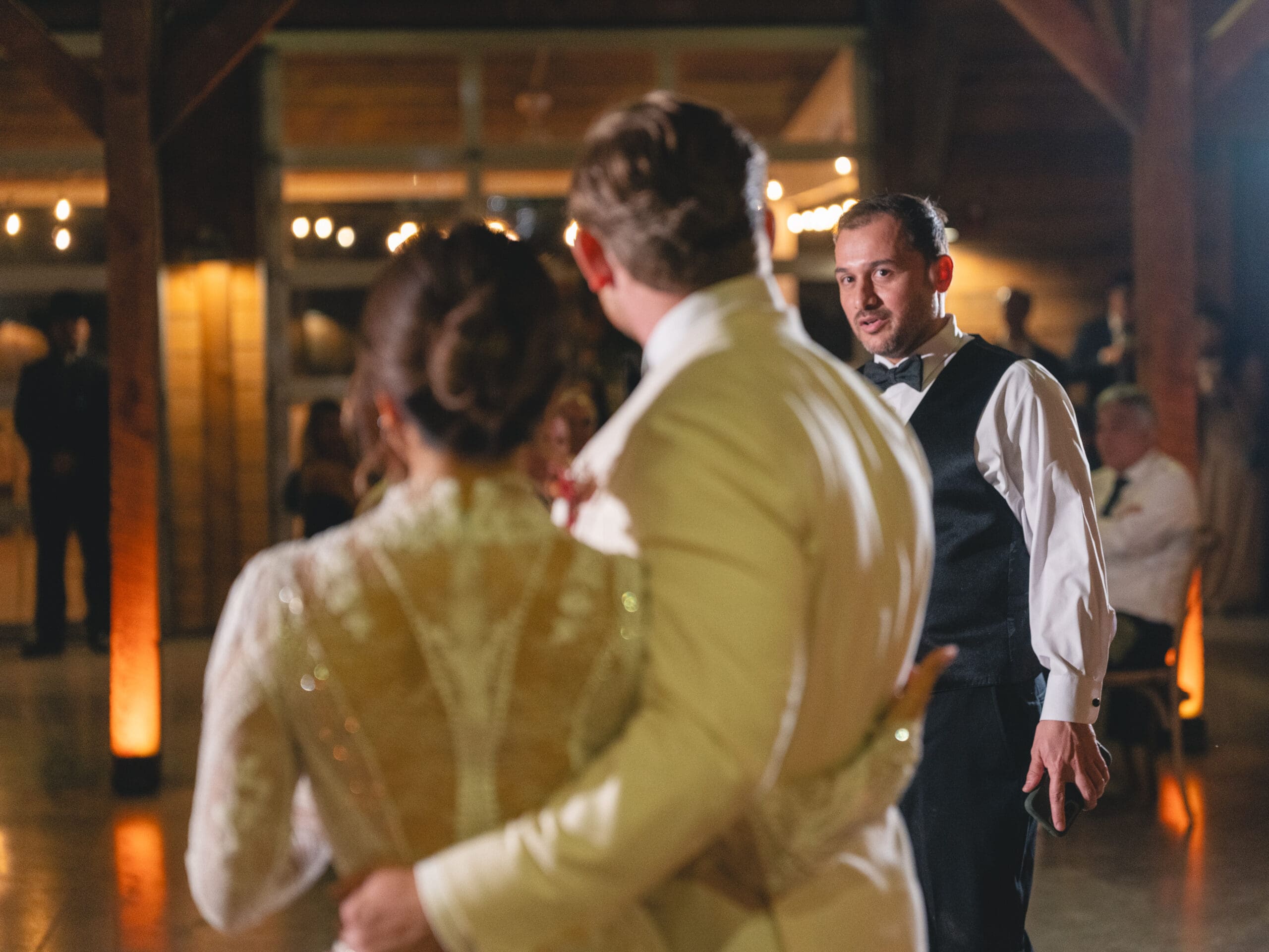 toasts Oanh and Jeremy in the barn at The Addison Grove surrounded by friends and family