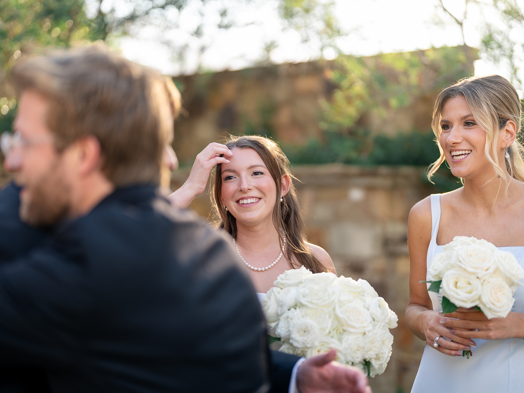 Outdoor ceremony moment at Escondido Golf Club with guests seated and floral arch backdrop