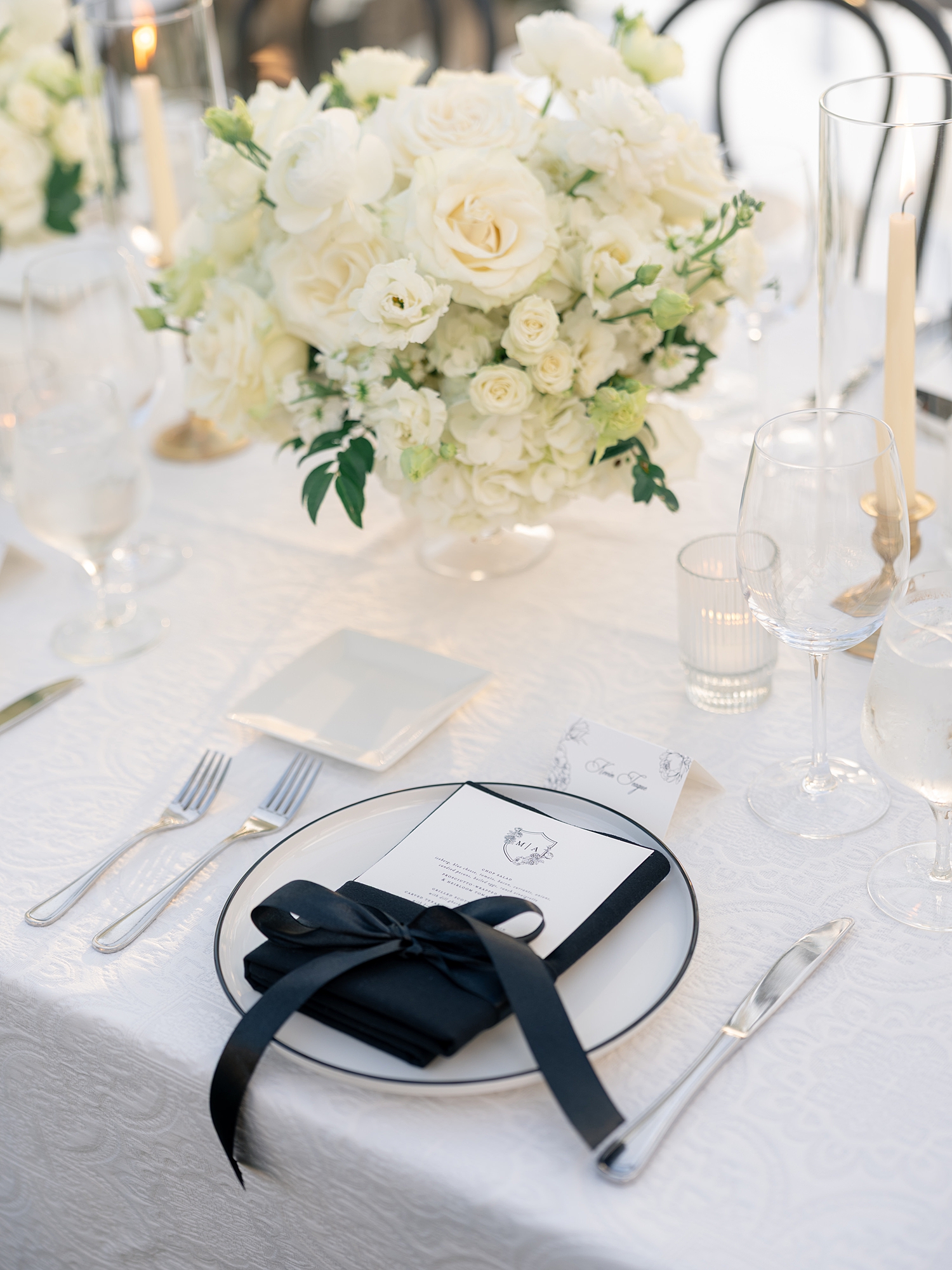 Reception tablescape with elegant linens, florals and candles at Escondido Golf Club