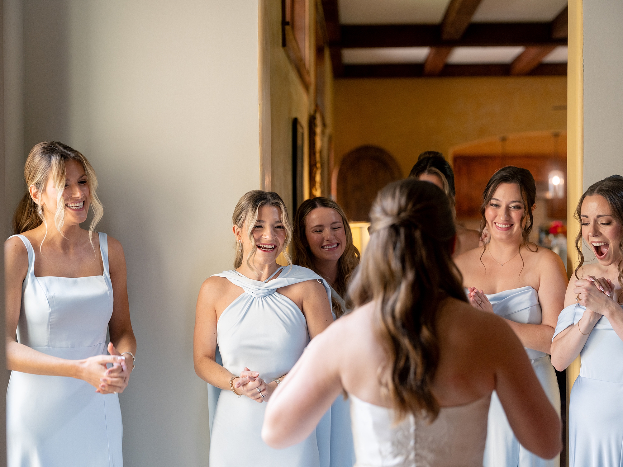 Bridal party getting ready in a sun-lit suite at Escondido Golf Club, captured on film