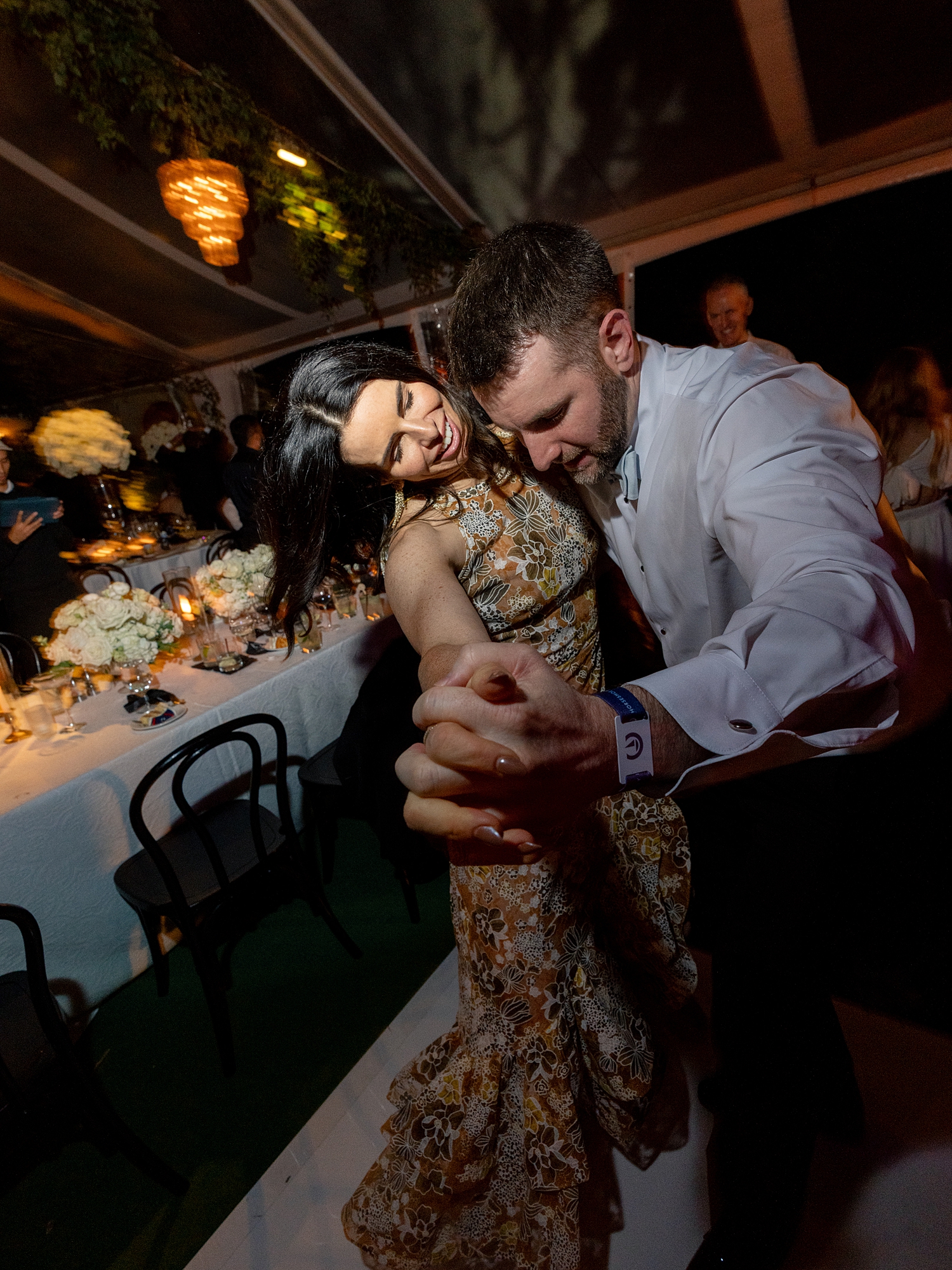 wedding guests dancing and celebrating on the dance floor at Escondido Golf Club wedding by Paige Vaughn Photo