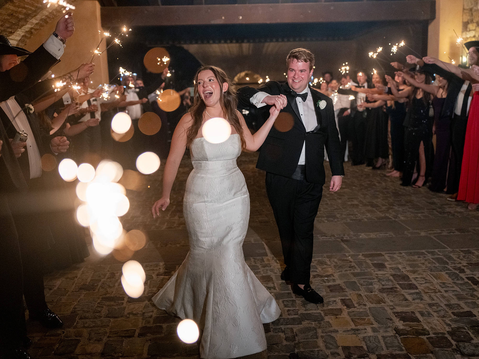 Nighttime exit of bride and groom amidst sparkler send-off at Escondido Golf Club, Texas wedding inspiration