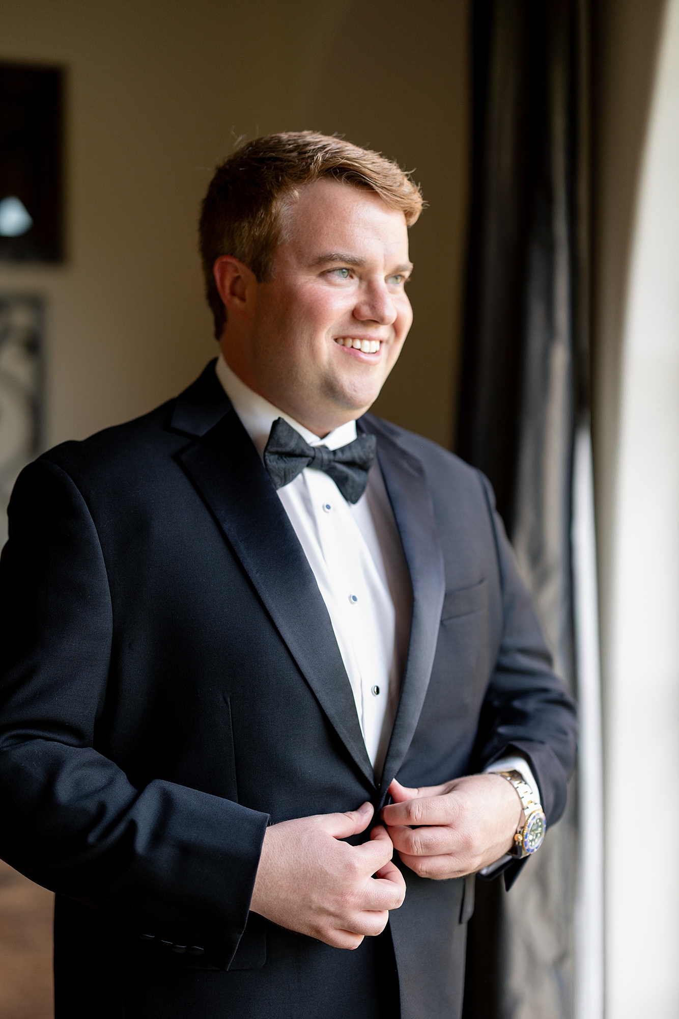 Groom adjusting his jacket before walking down the aisle at Escondido Golf Club wedding