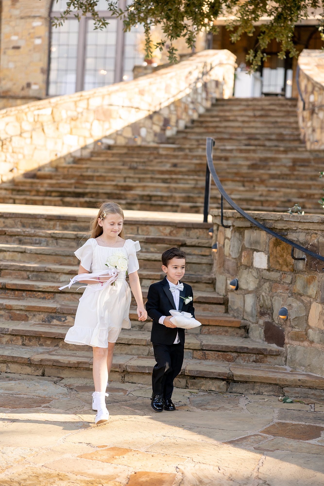 Outdoor ceremony moment at Escondido Golf Club with guests seated and floral arch backdrop