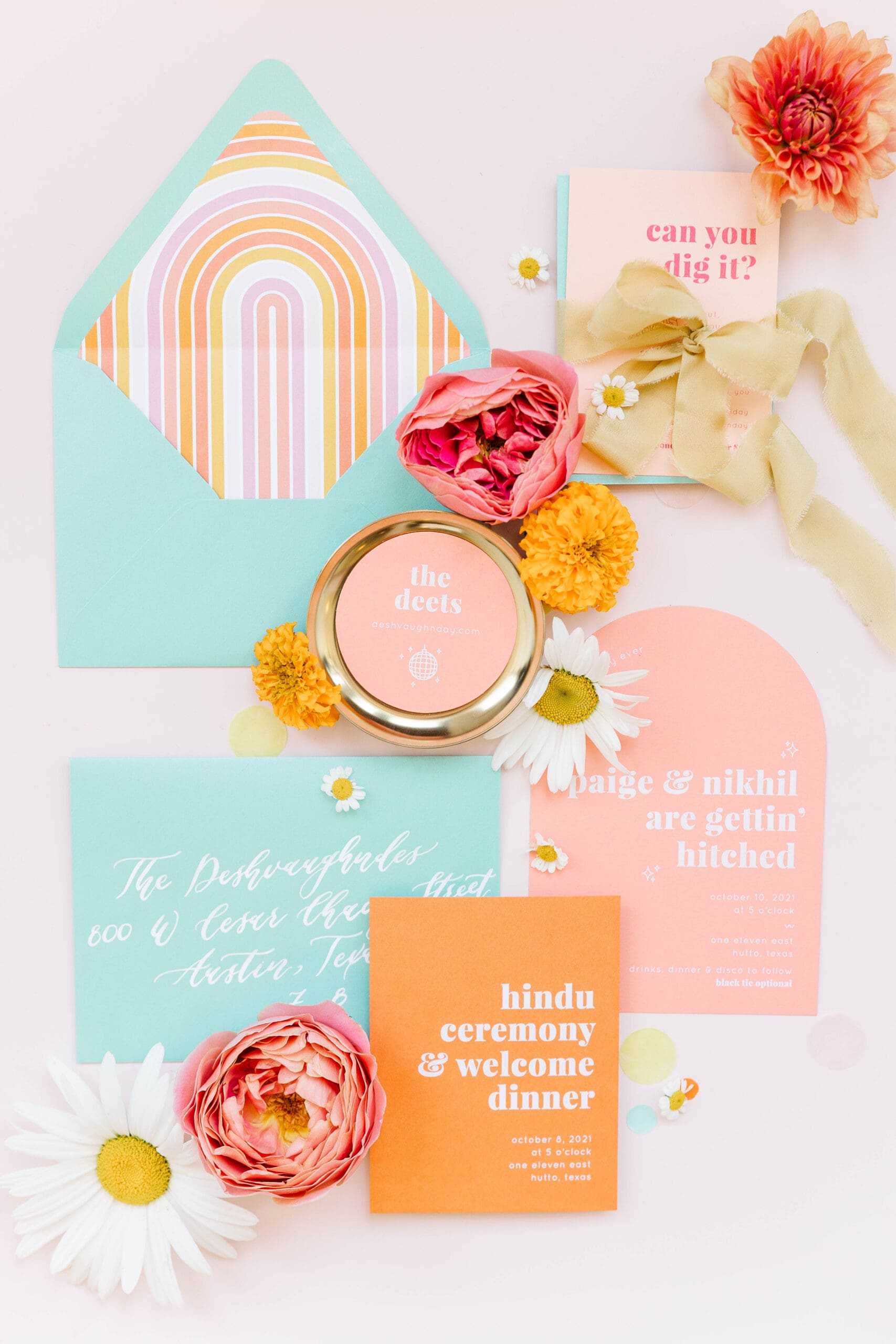 Detail photo of colorful stationery, bold florals and textured linens from the multi-day celebration