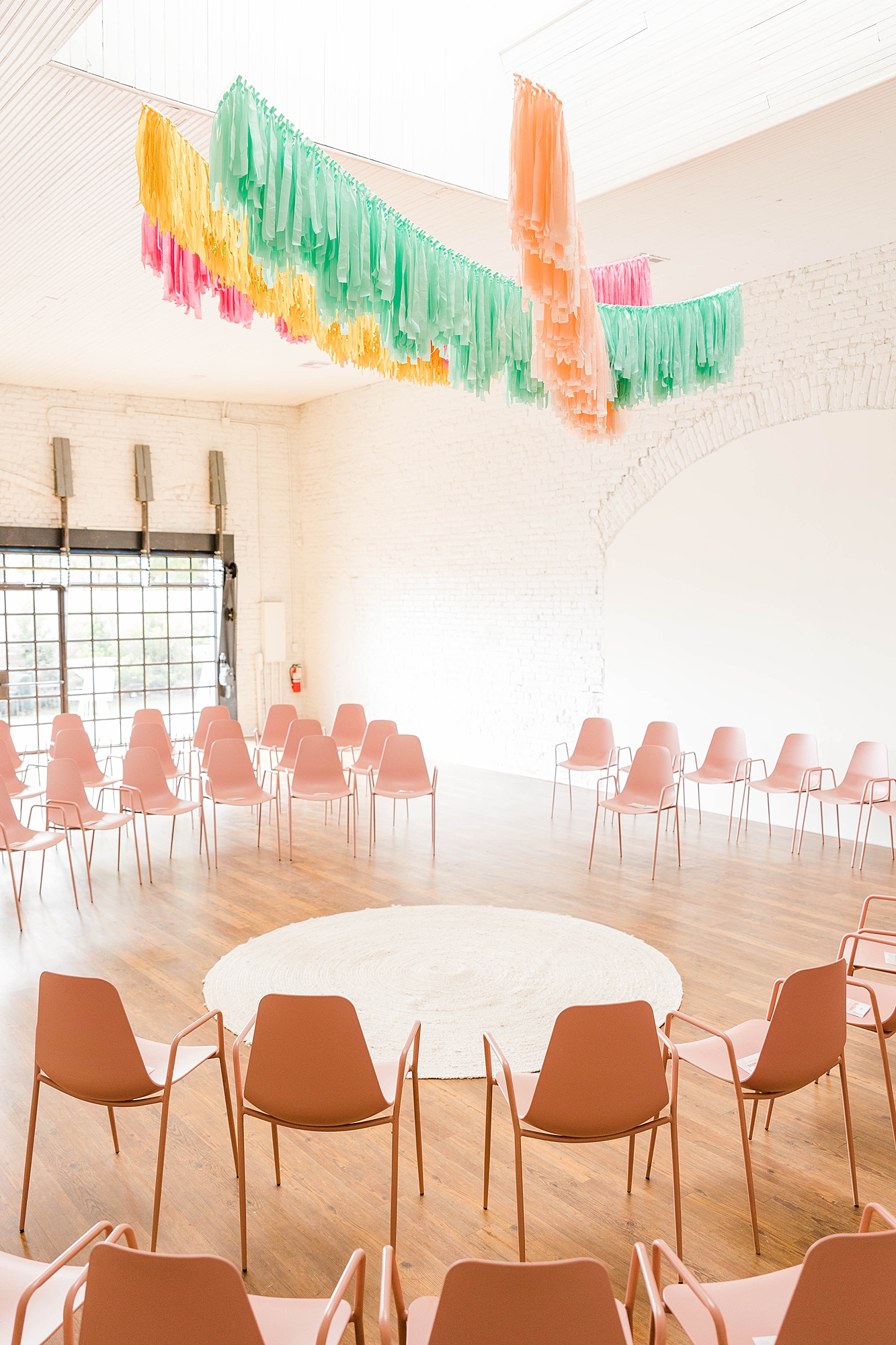 Western reception with retro-inspired decor in peach, mustard, teal and orange, guests dancing under fall light