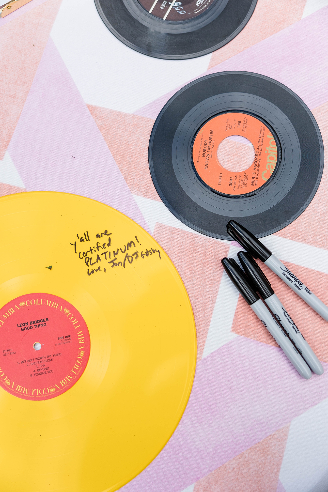 Western reception with retro-inspired decor in peach, mustard, teal and orange, guests dancing under fall light