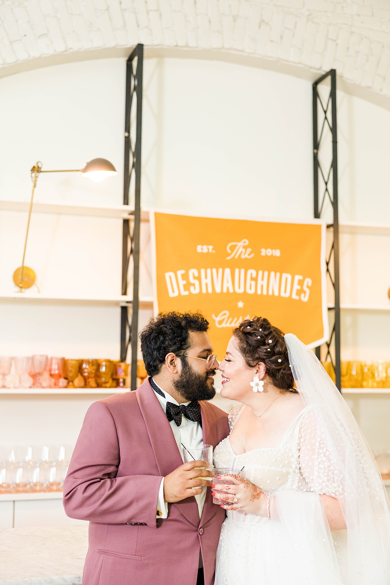 Western reception with retro-inspired decor in peach, mustard, teal and orange, guests dancing under fall light