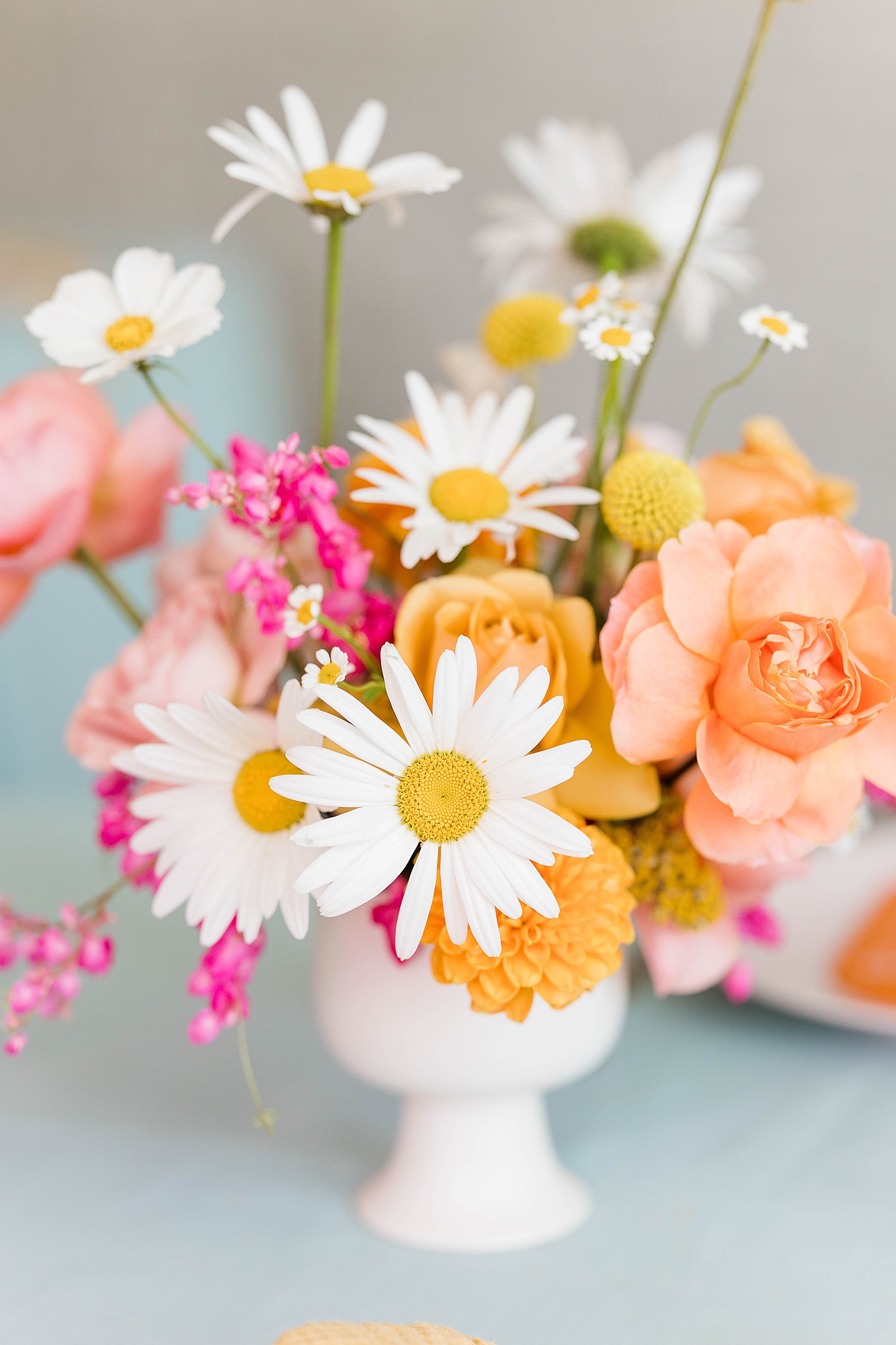 Western reception with retro-inspired decor in peach, mustard, teal and orange, guests dancing under fall light