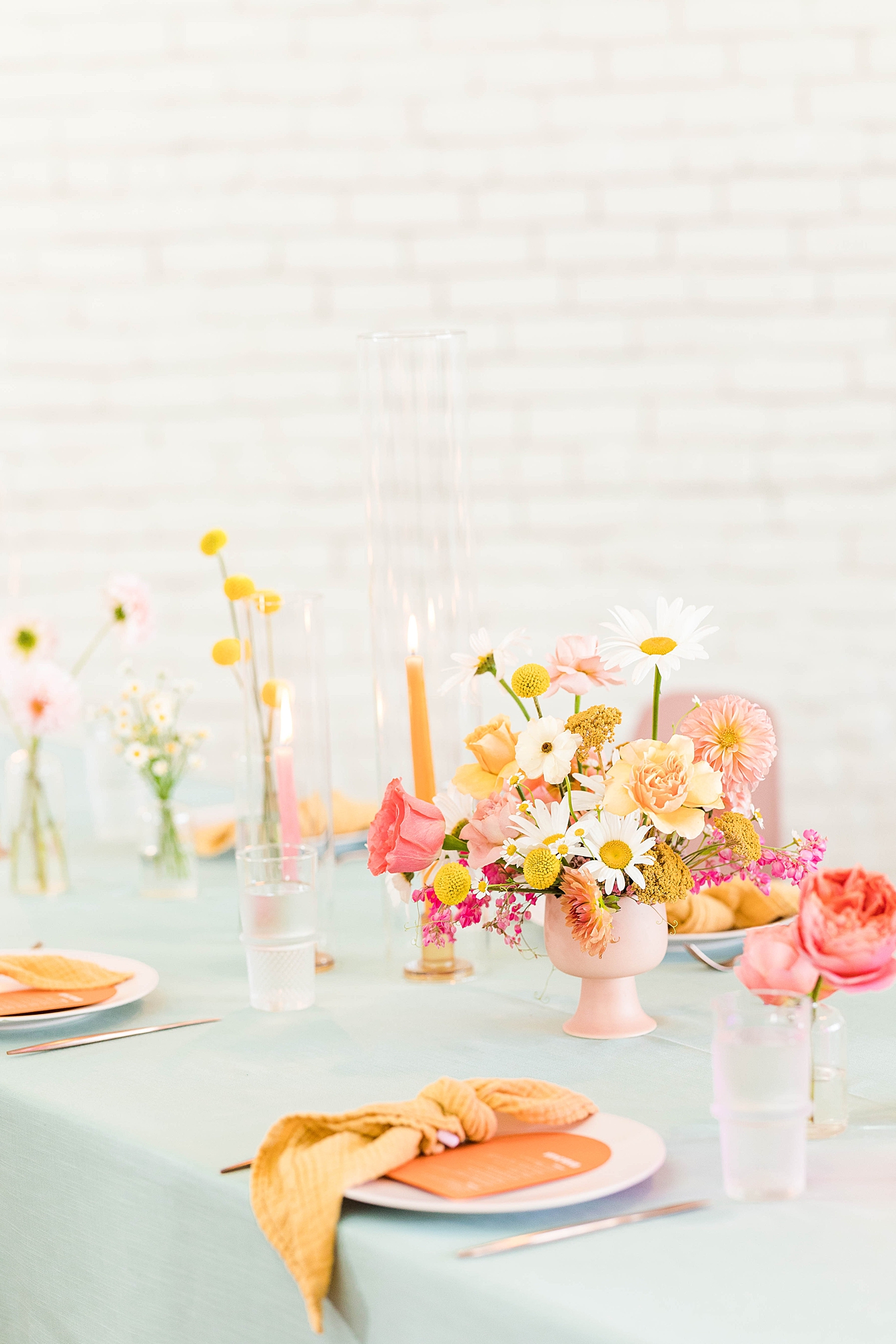 Western reception with retro-inspired decor in peach, mustard, teal and orange, guests dancing under fall light
