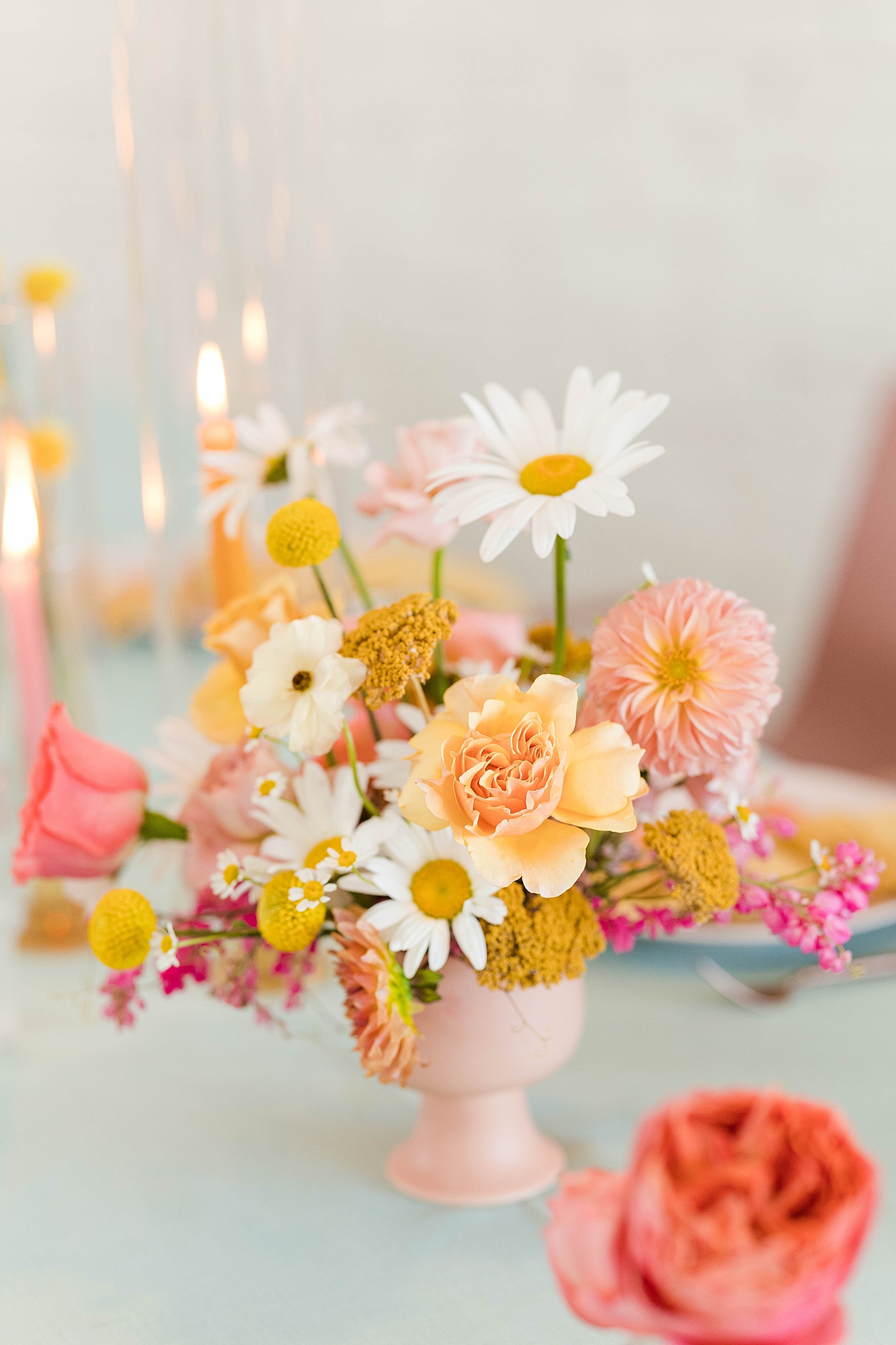 Western reception with retro-inspired decor in peach, mustard, teal and orange, guests dancing under fall light