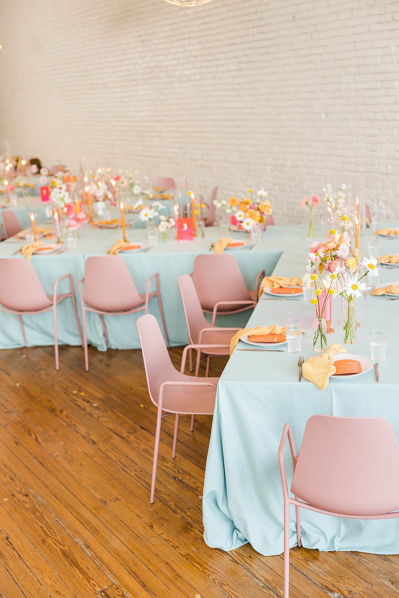 Western reception with retro-inspired decor in peach, mustard, teal and orange, guests dancing under fall light