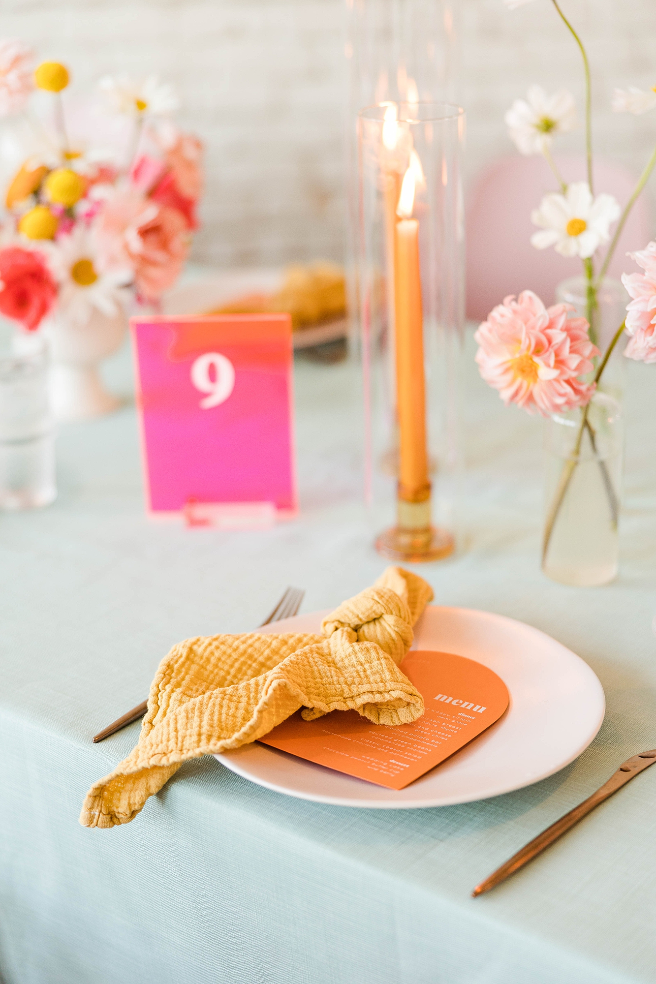 Western reception with retro-inspired decor in peach, mustard, teal and orange, guests dancing under fall light