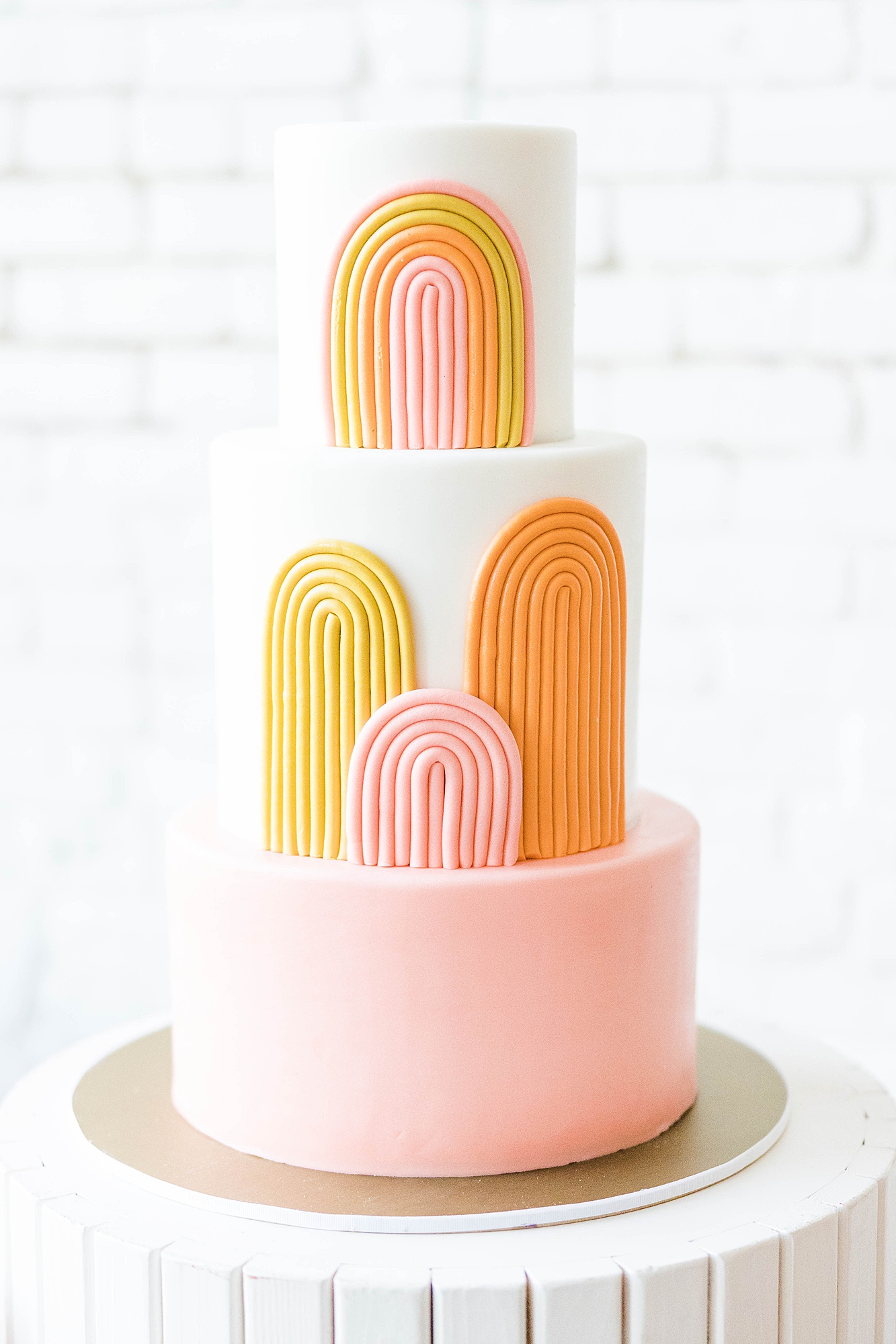 Western reception with retro-inspired decor in peach, mustard, teal and orange, guests dancing under fall light