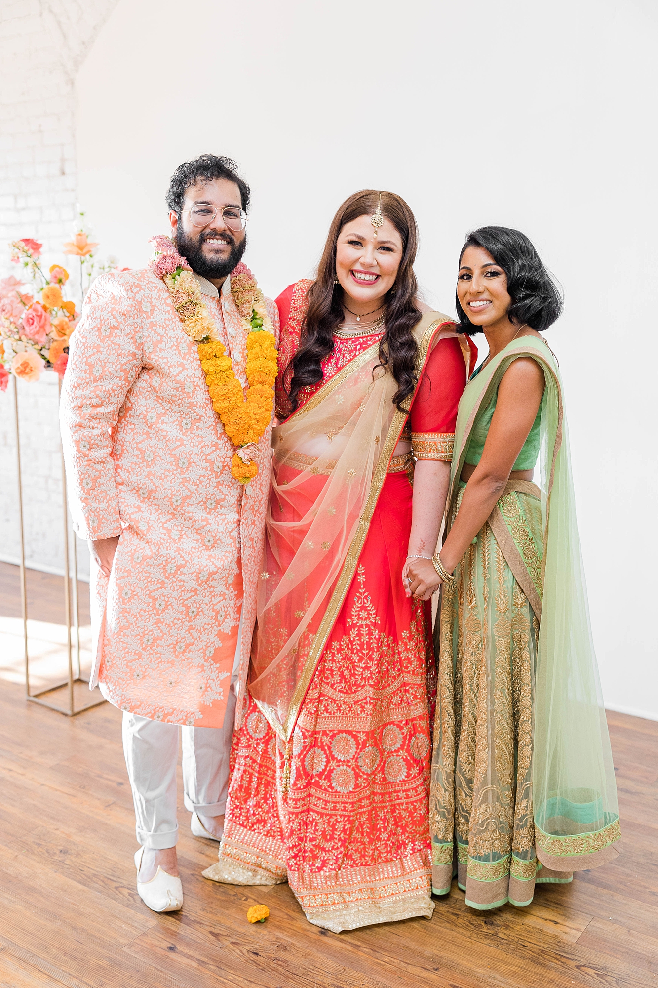 Bride in pink and red lengha honoring Indian heritage, photographed by Paige Vaughn Photo