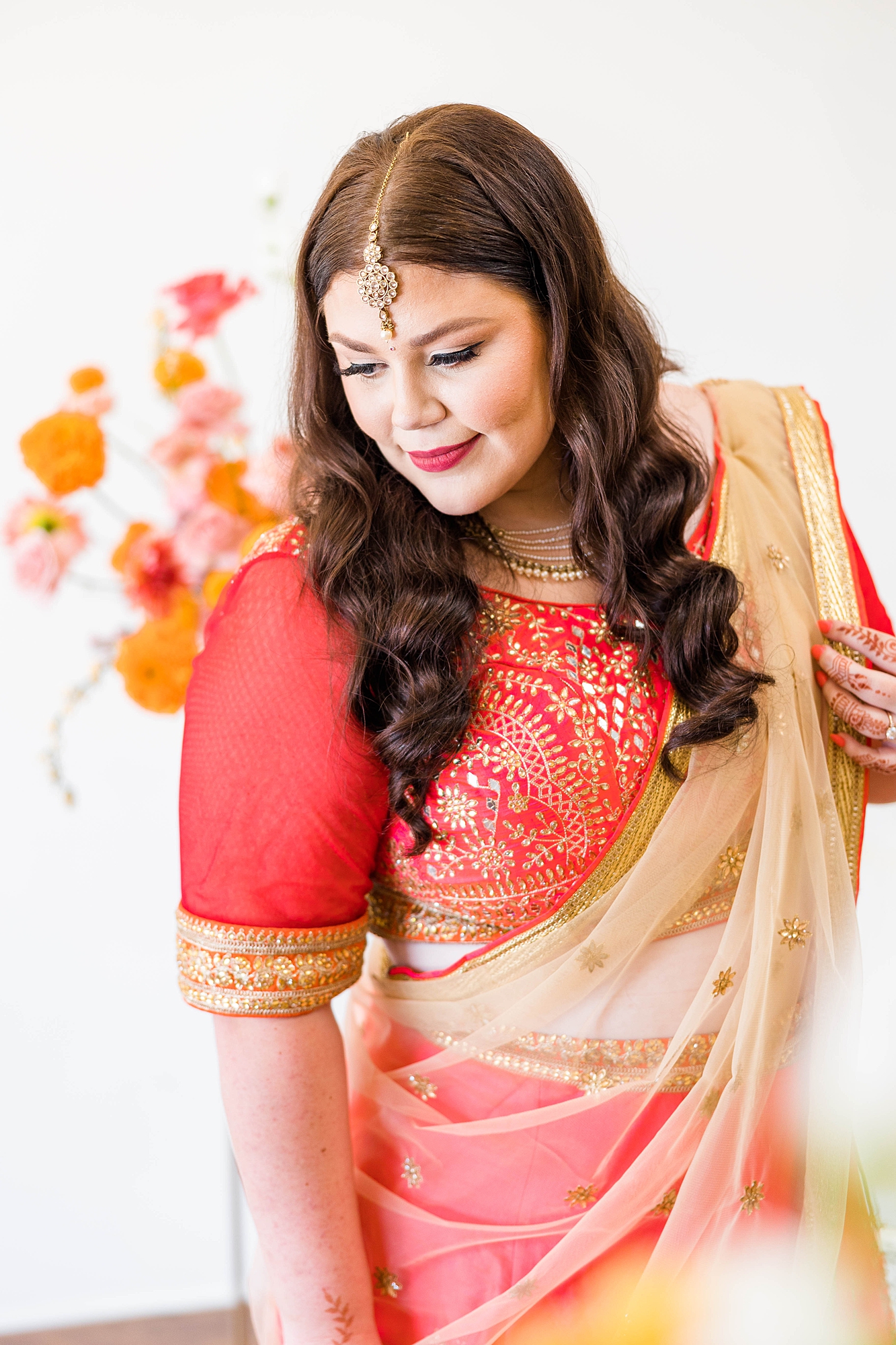 Bride in pink and red lengha honoring Indian heritage, photographed by Paige Vaughn Photo