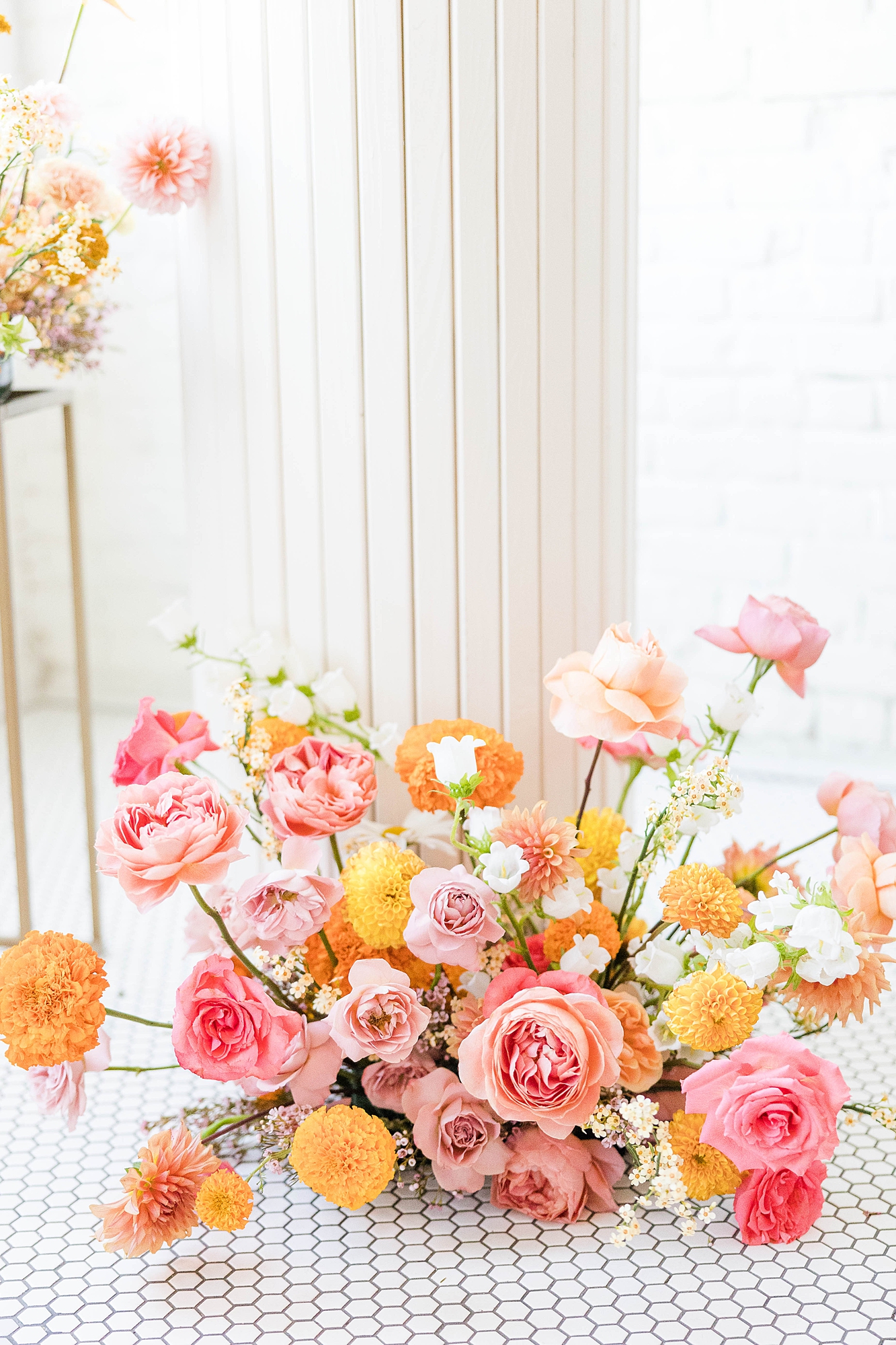 Western reception with retro-inspired decor in peach, mustard, teal and orange, guests dancing under fall light