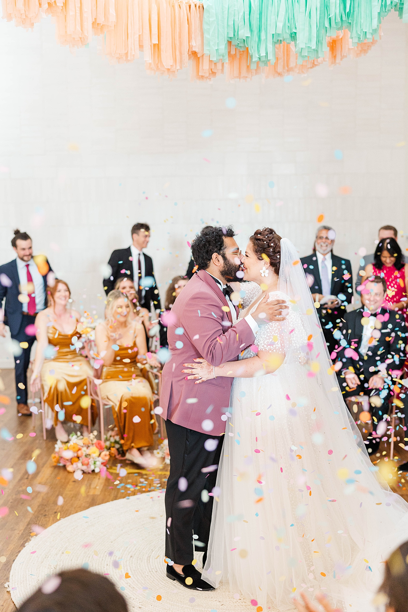 Autumn wedding ceremony with deep jewel tones, fun patterns and joyful family moments