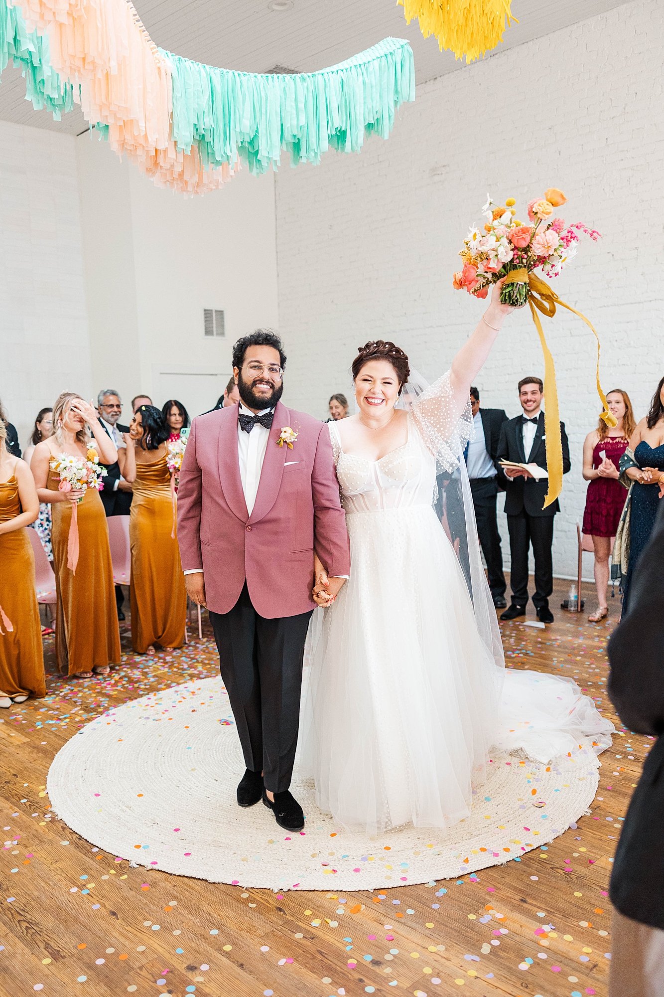 Autumn wedding ceremony with deep jewel tones, fun patterns and joyful family moments