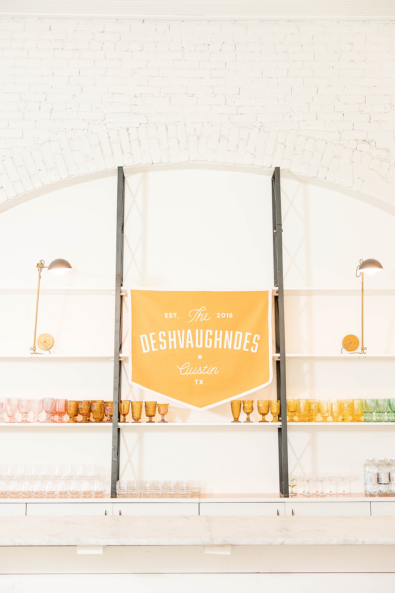 Western reception with retro-inspired decor in peach, mustard, teal and orange, guests dancing under fall light