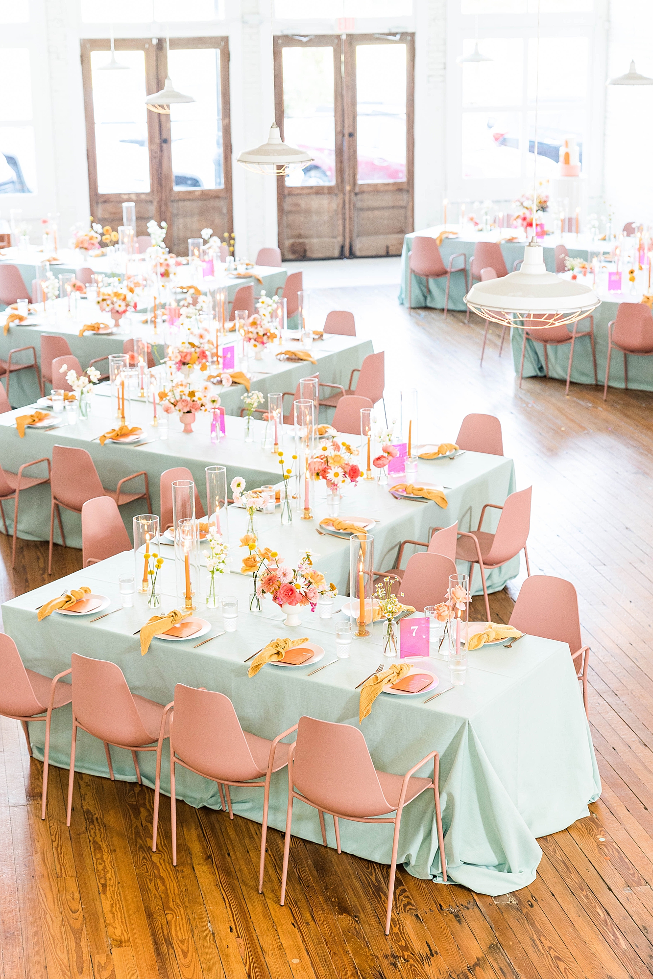 Western reception with retro-inspired decor in peach, mustard, teal and orange, guests dancing under fall light